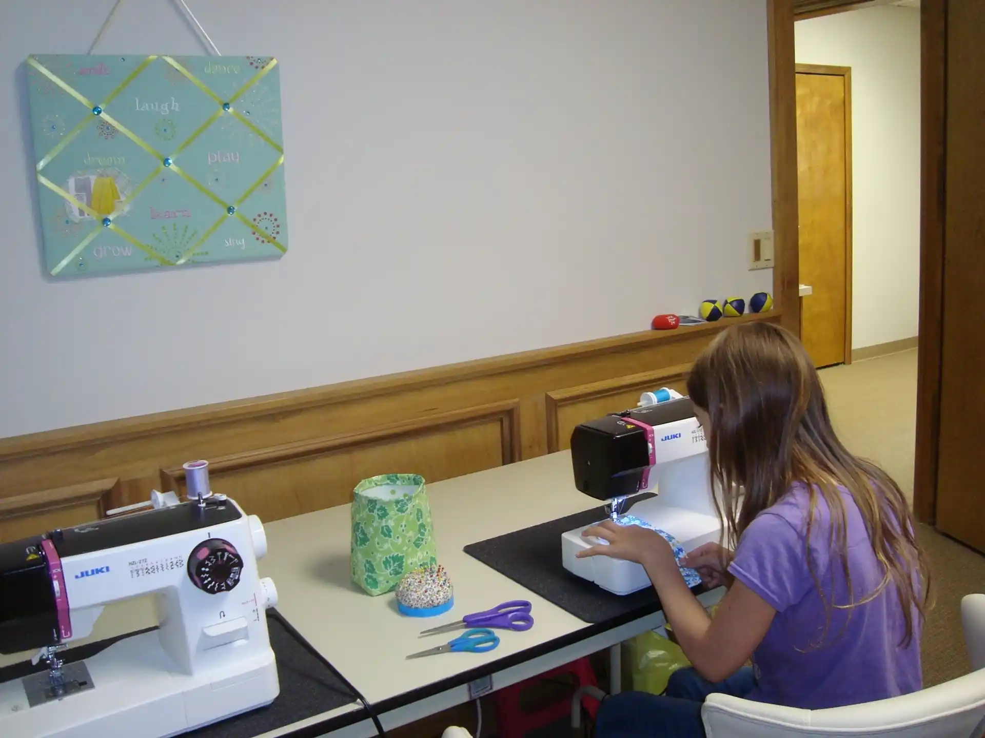 a woman sewing on a table