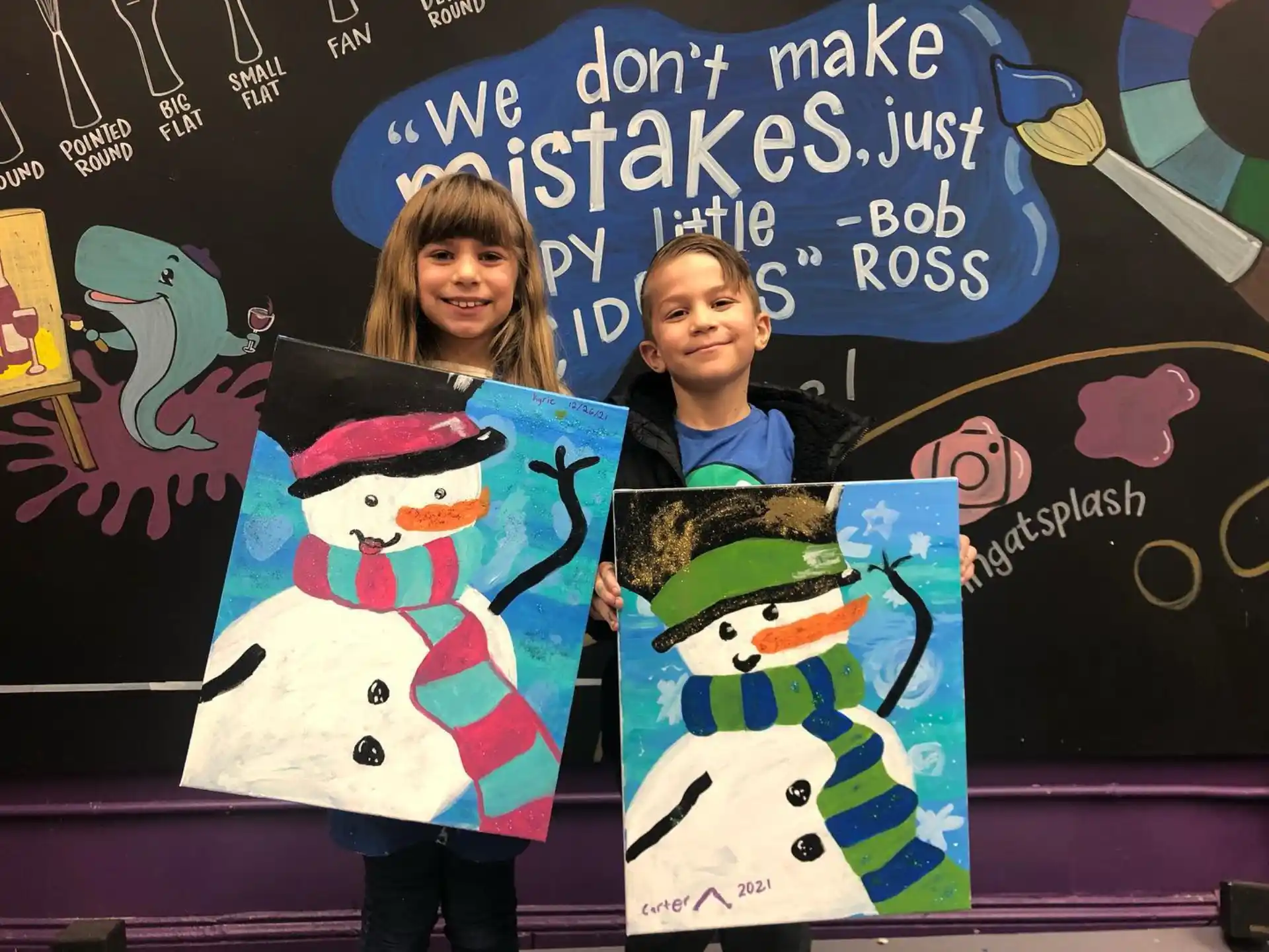 a couple of girls holding a graduation cap and gown