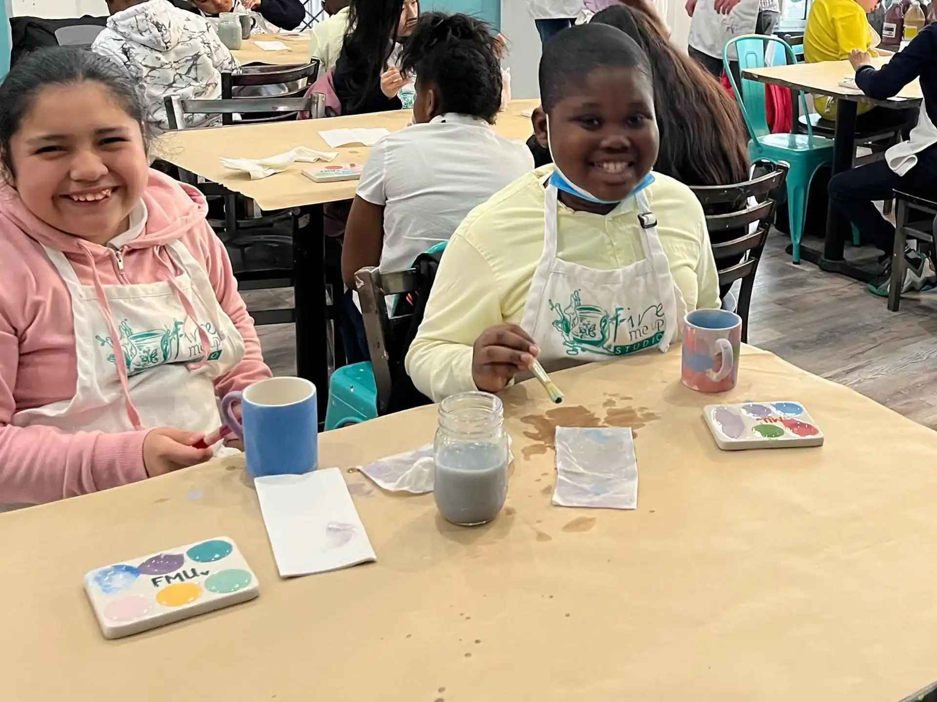 a group of children sitting at a table