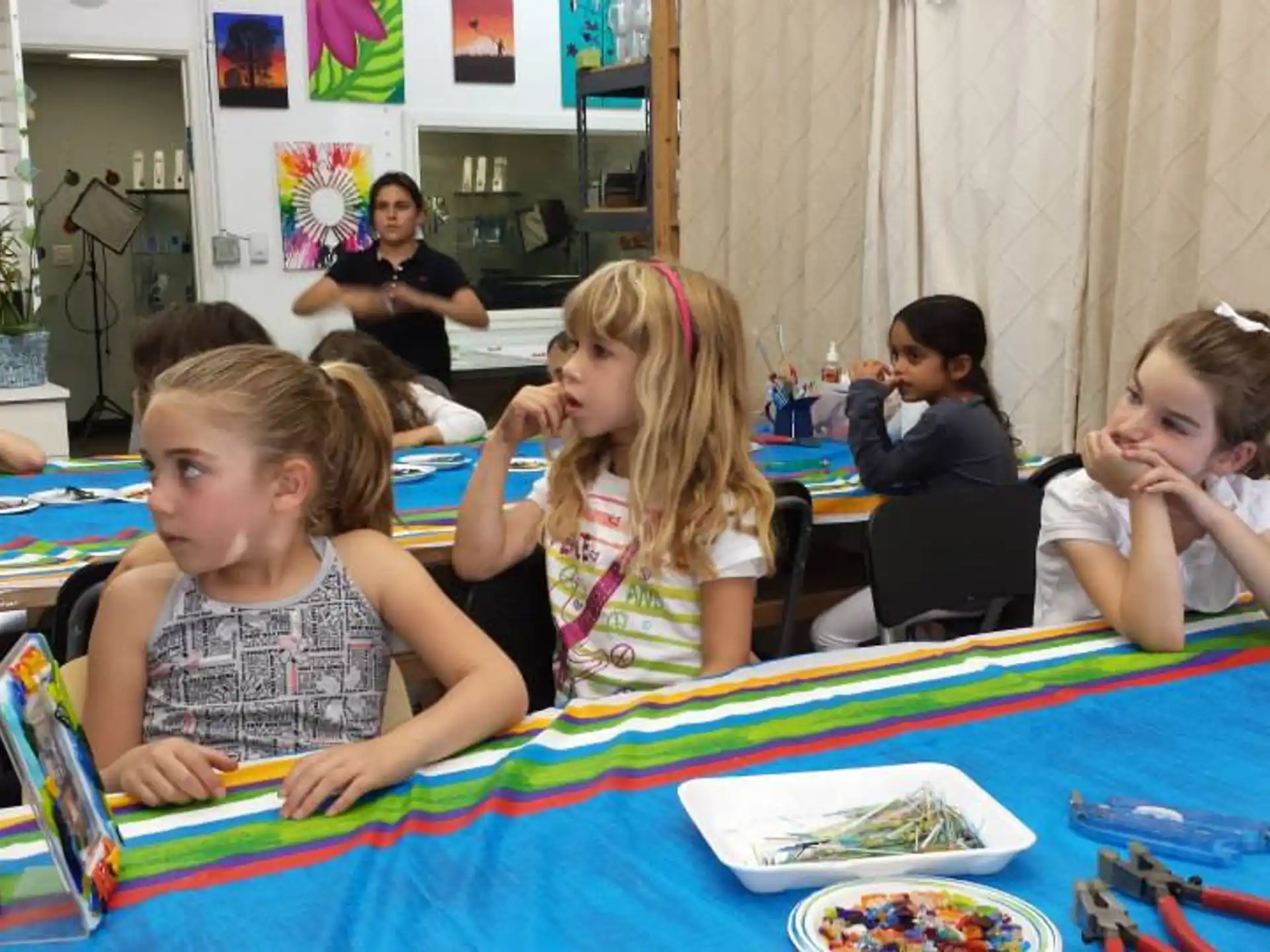 a group of children sitting at a table