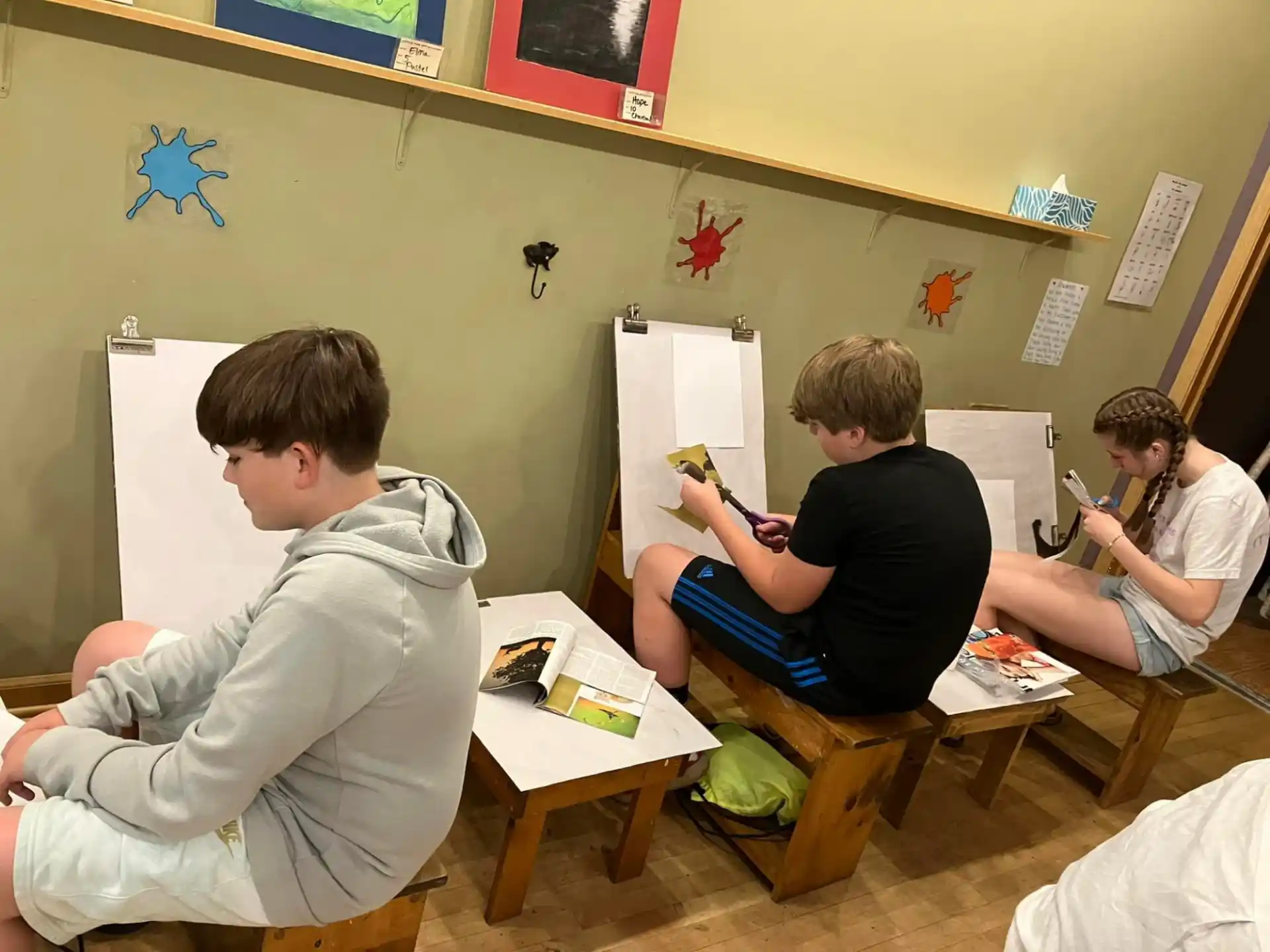 a group of boys sitting at desks in a classroom