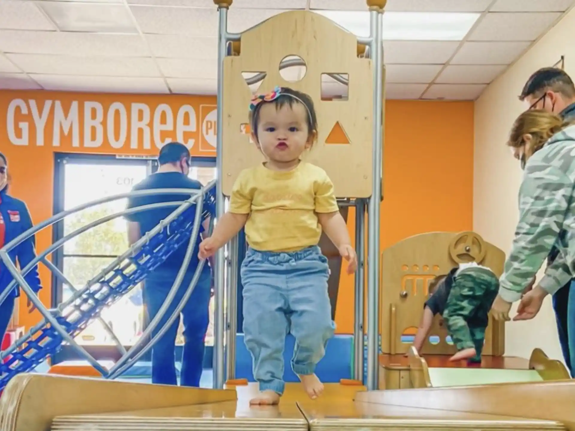 a child standing on a wooden platform