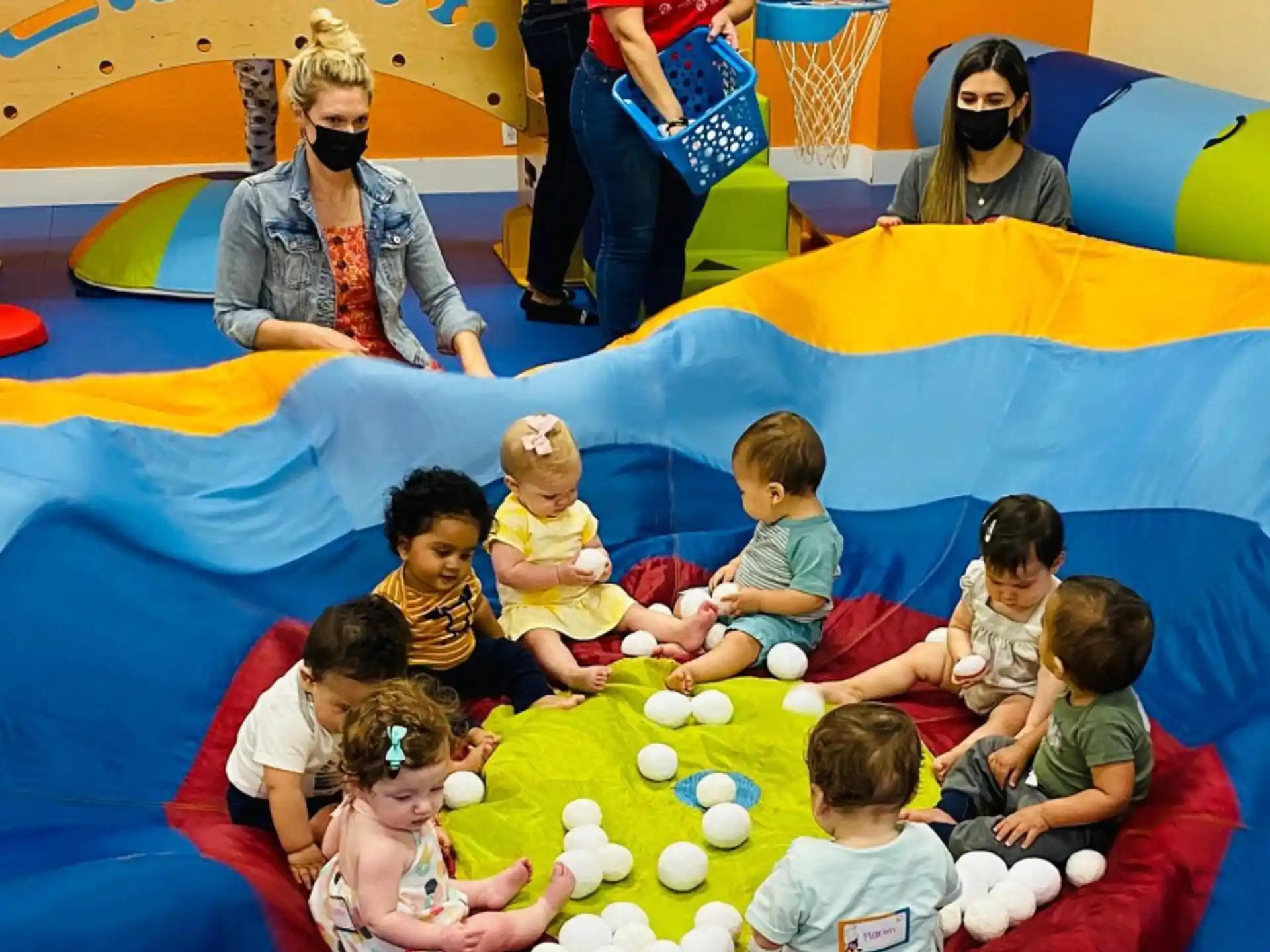a group of people sitting on a colorful slide