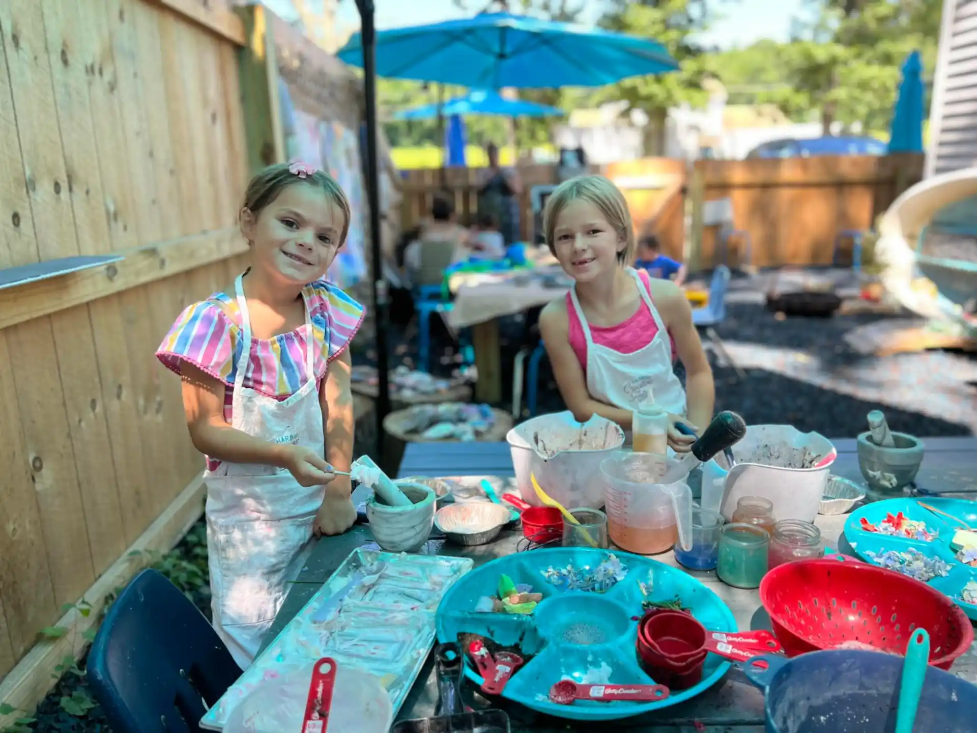 a couple of girls cooking outside