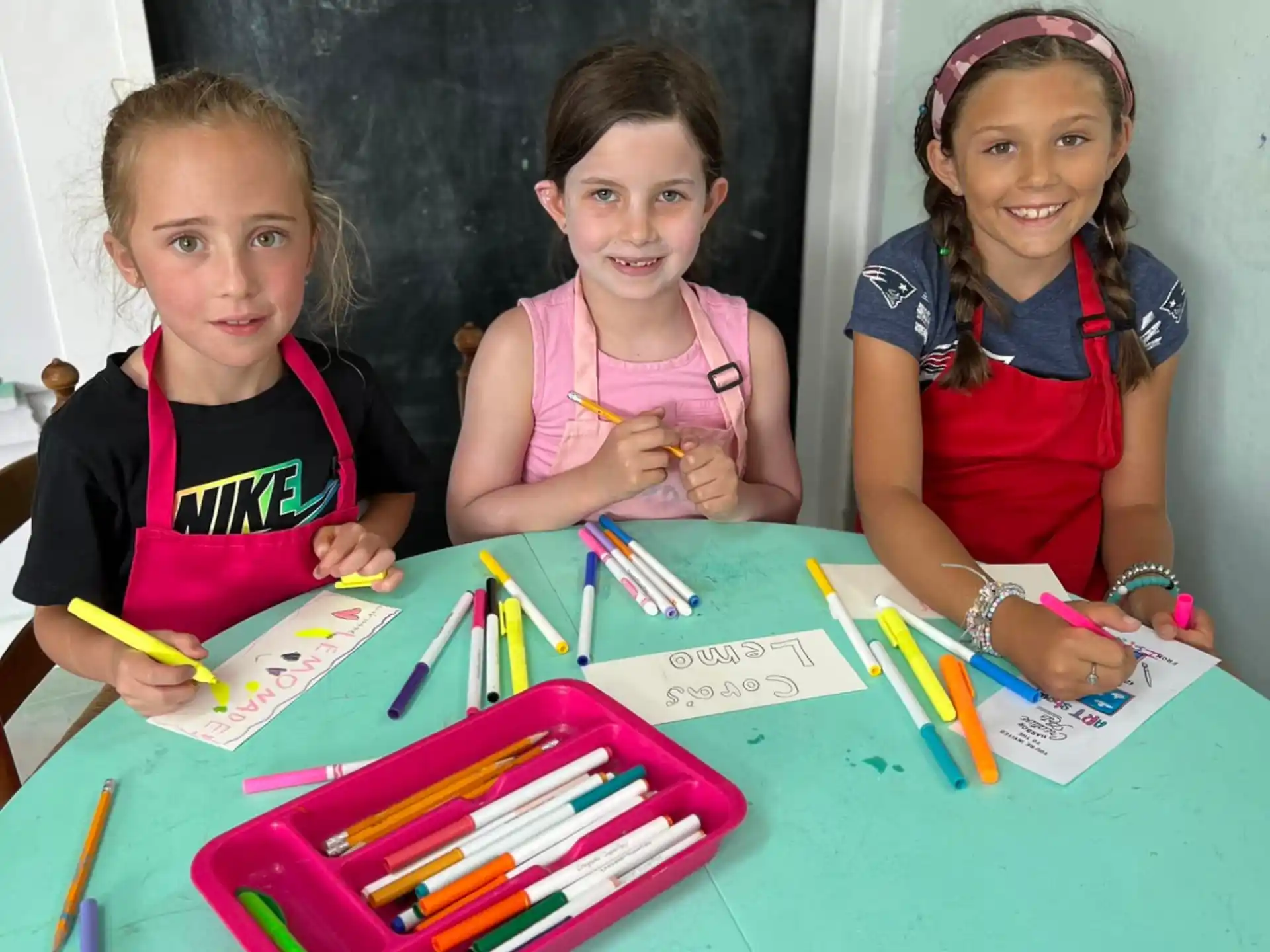 a group of children sitting at a table with a colorful board game