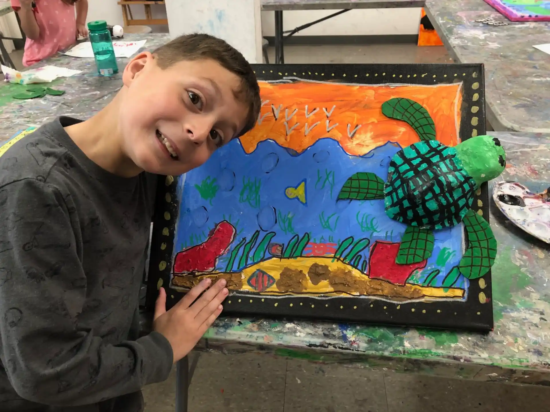 a boy holding a painting