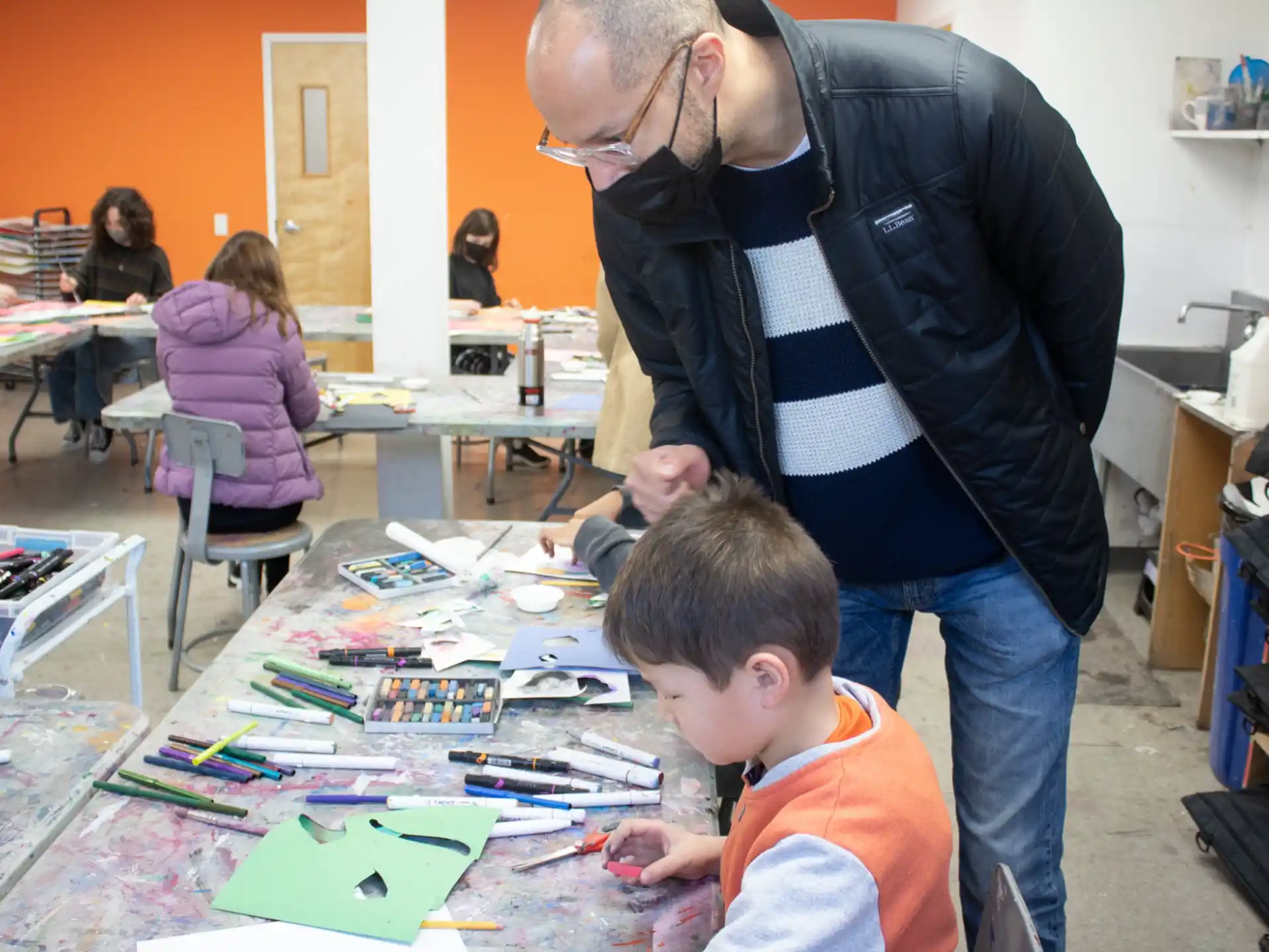 a person and a boy playing a board game