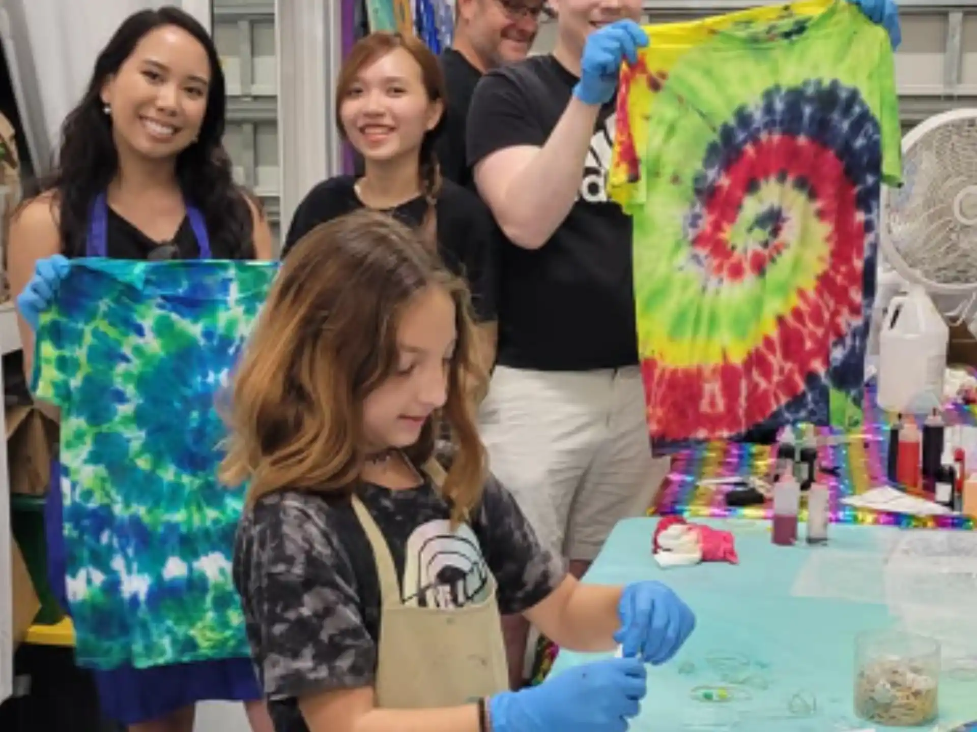 a group of people standing around a table with a flag