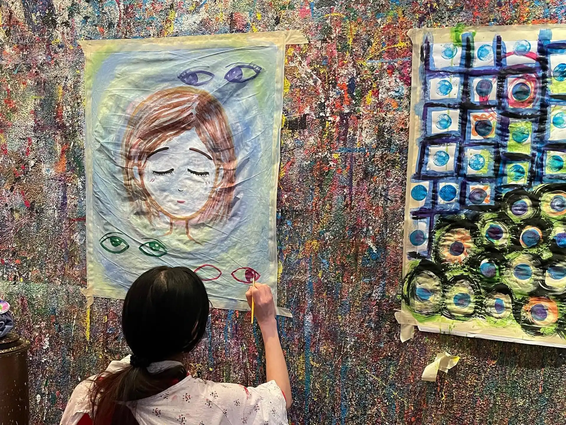 a girl painting on a wall