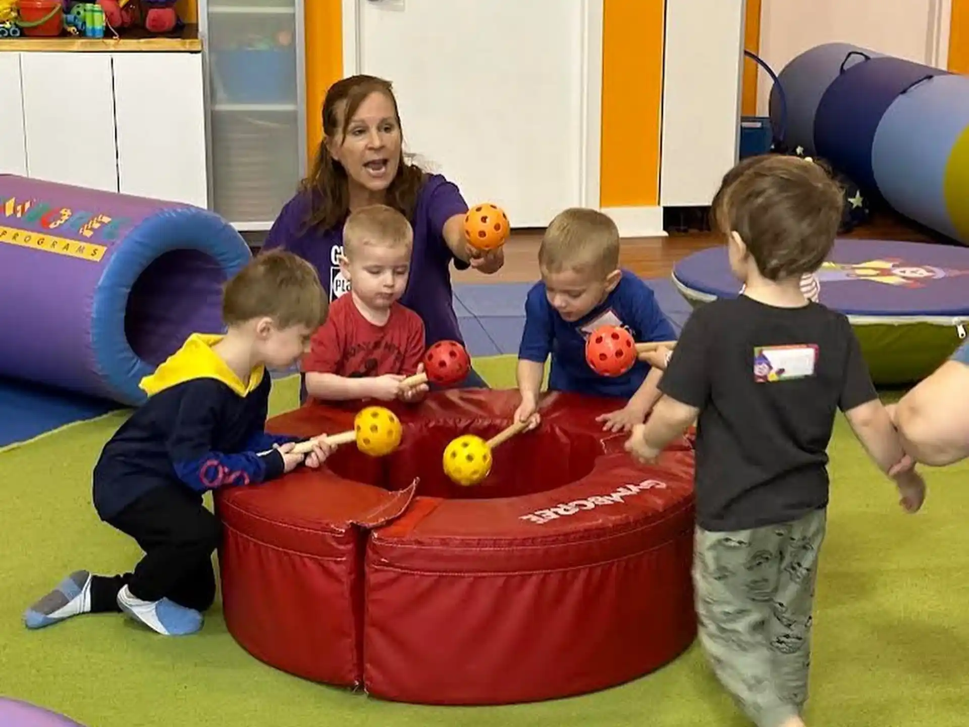 a group of children playing in a ball pit