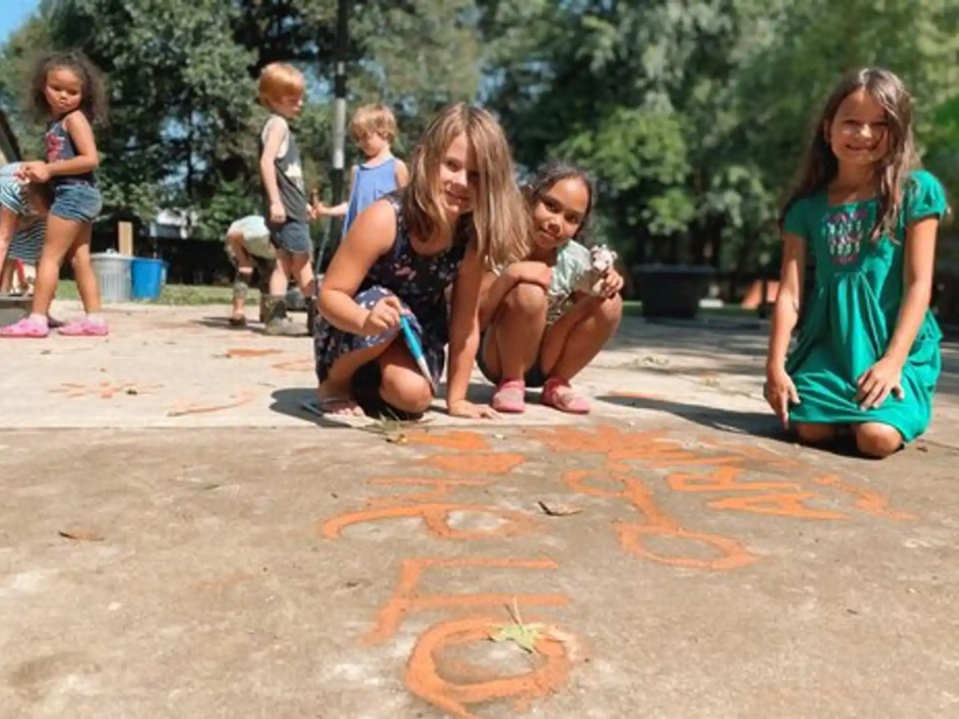 a group of children sitting on the ground