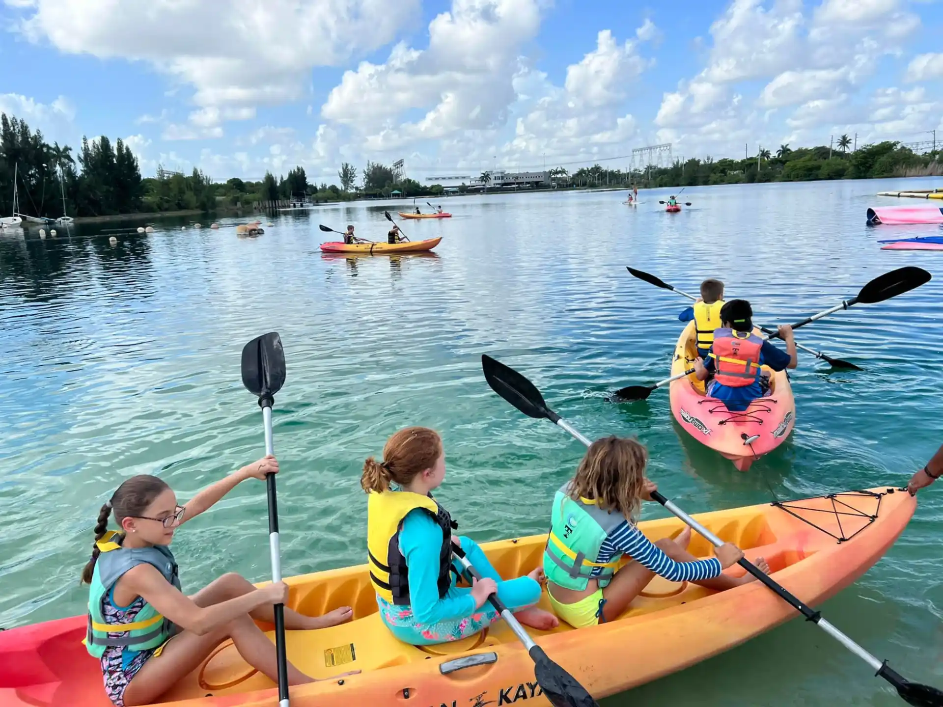 a group of people in kayaks on a lake