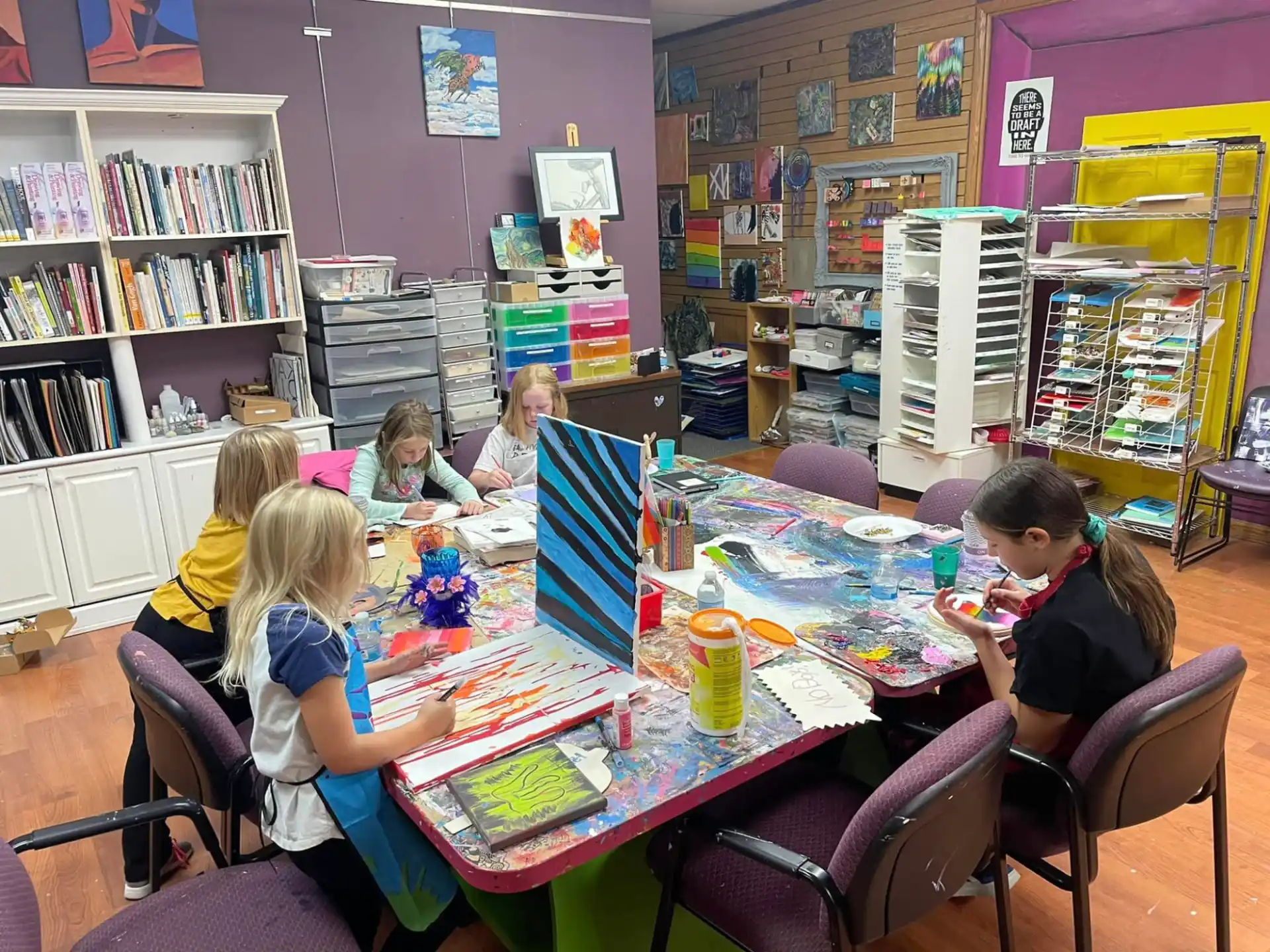 a group of children sitting around a table
