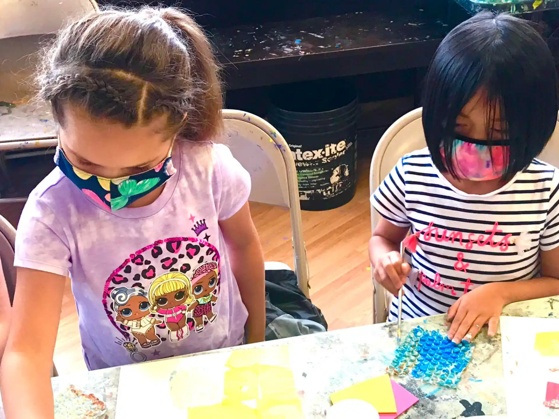 a couple of kids wearing masks