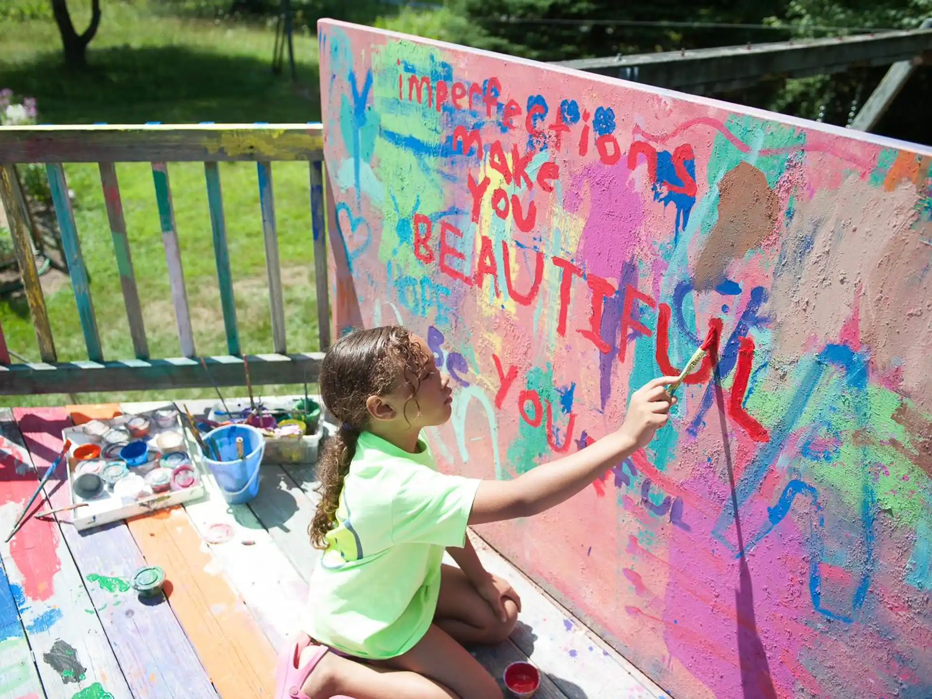 a girl painting on a wall