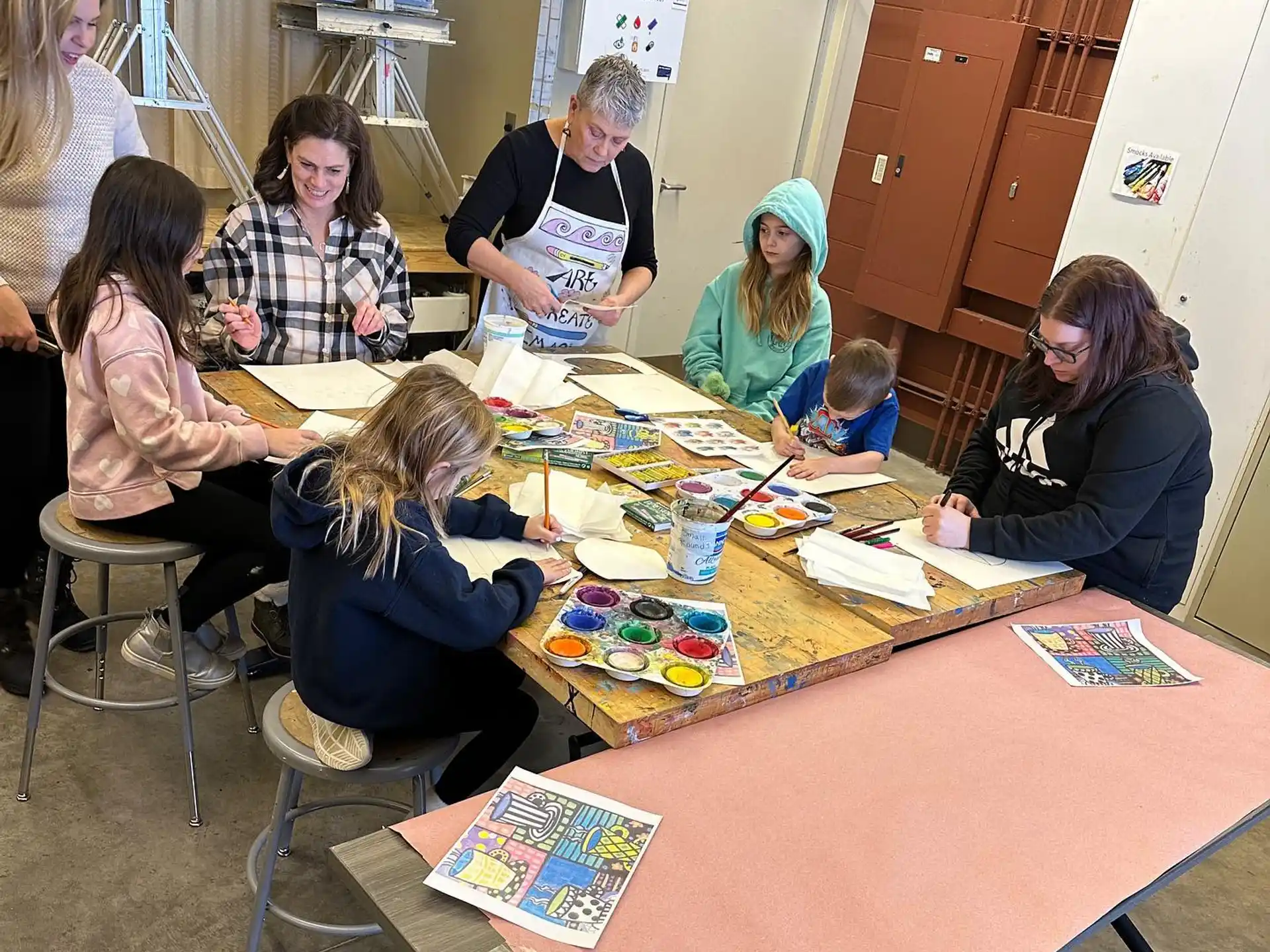 a group of people sitting around a table with food on it