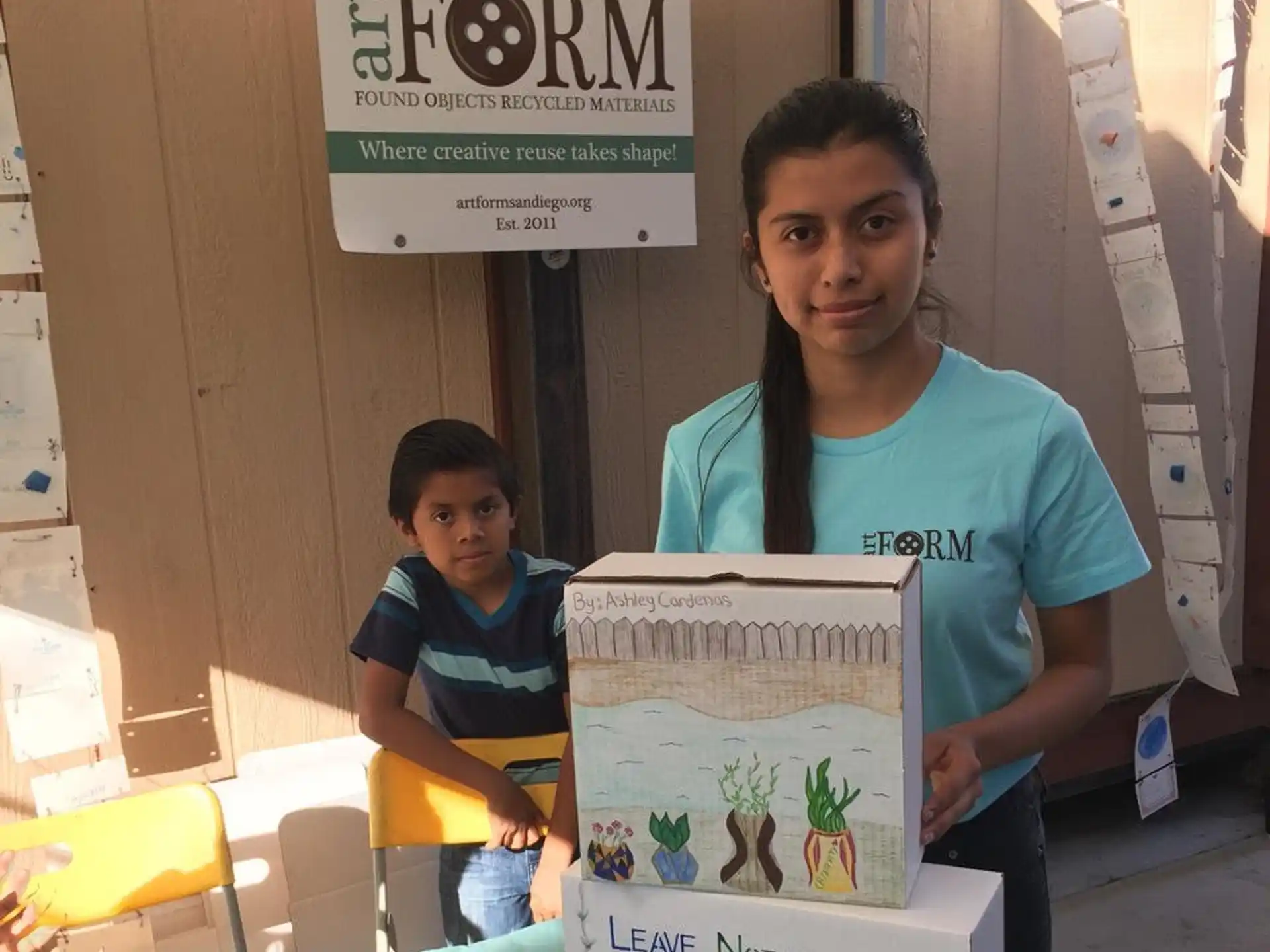 a person and a child standing next to a box