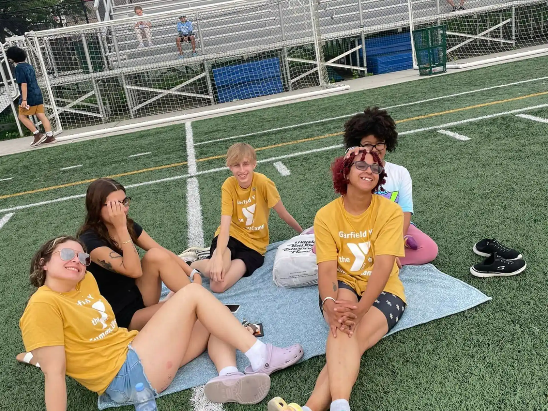 a group of people sitting on a football field