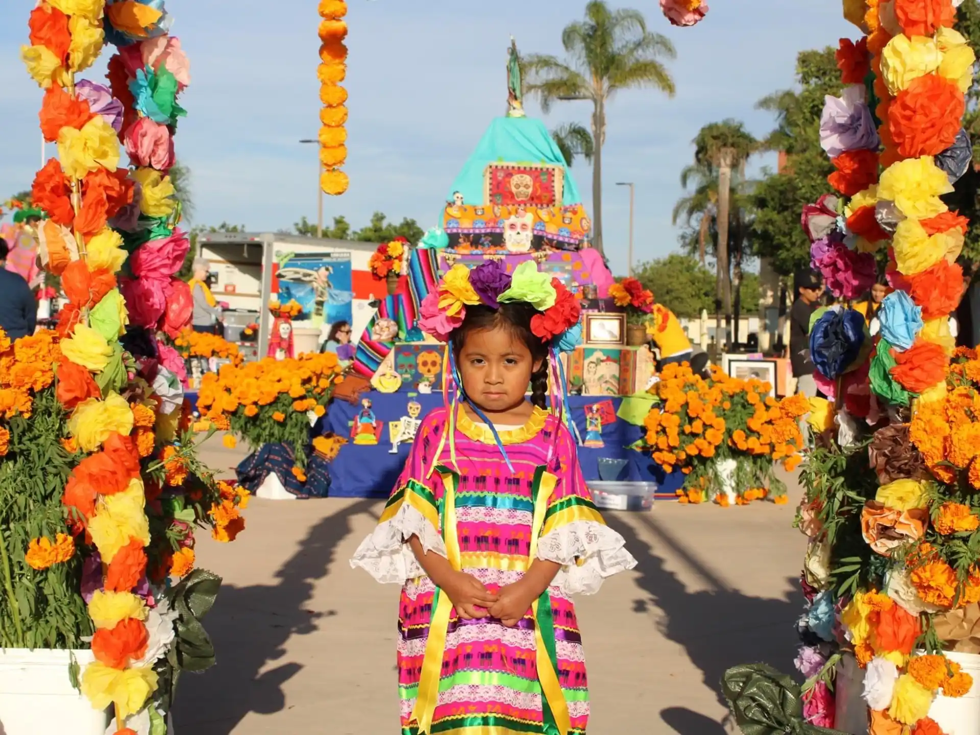 a girl standing in front of a flower display