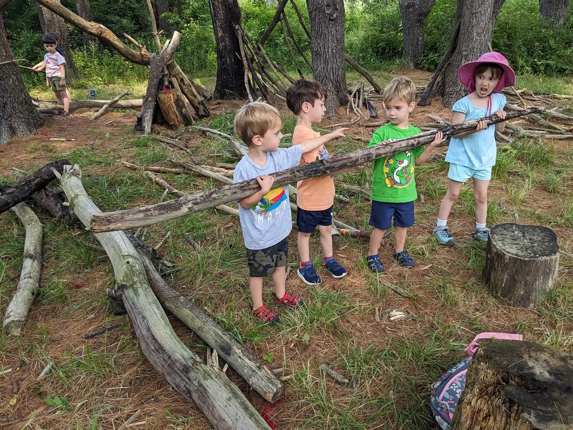 a group of children standing in a forest