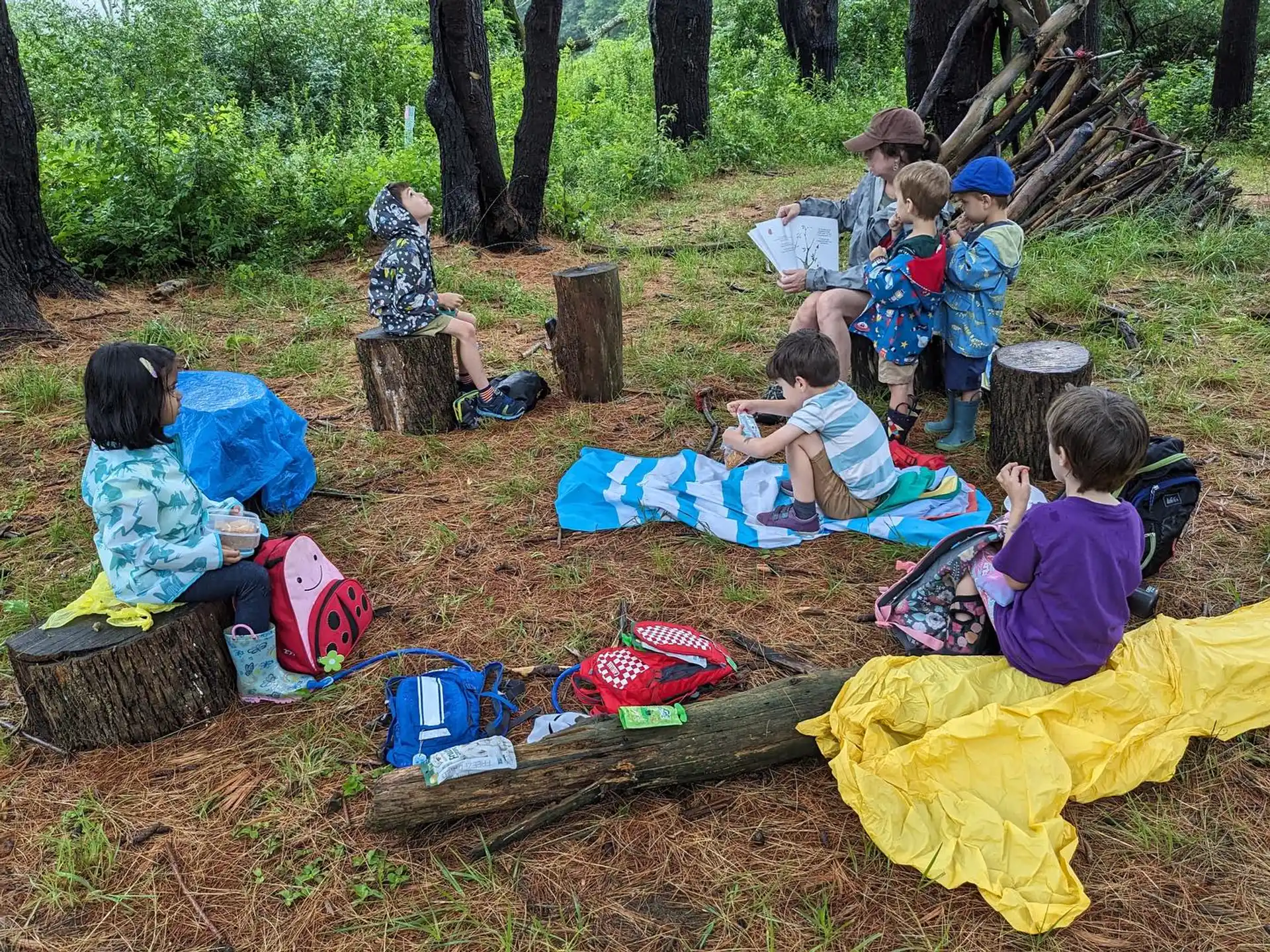 a group of people sitting on the ground outside