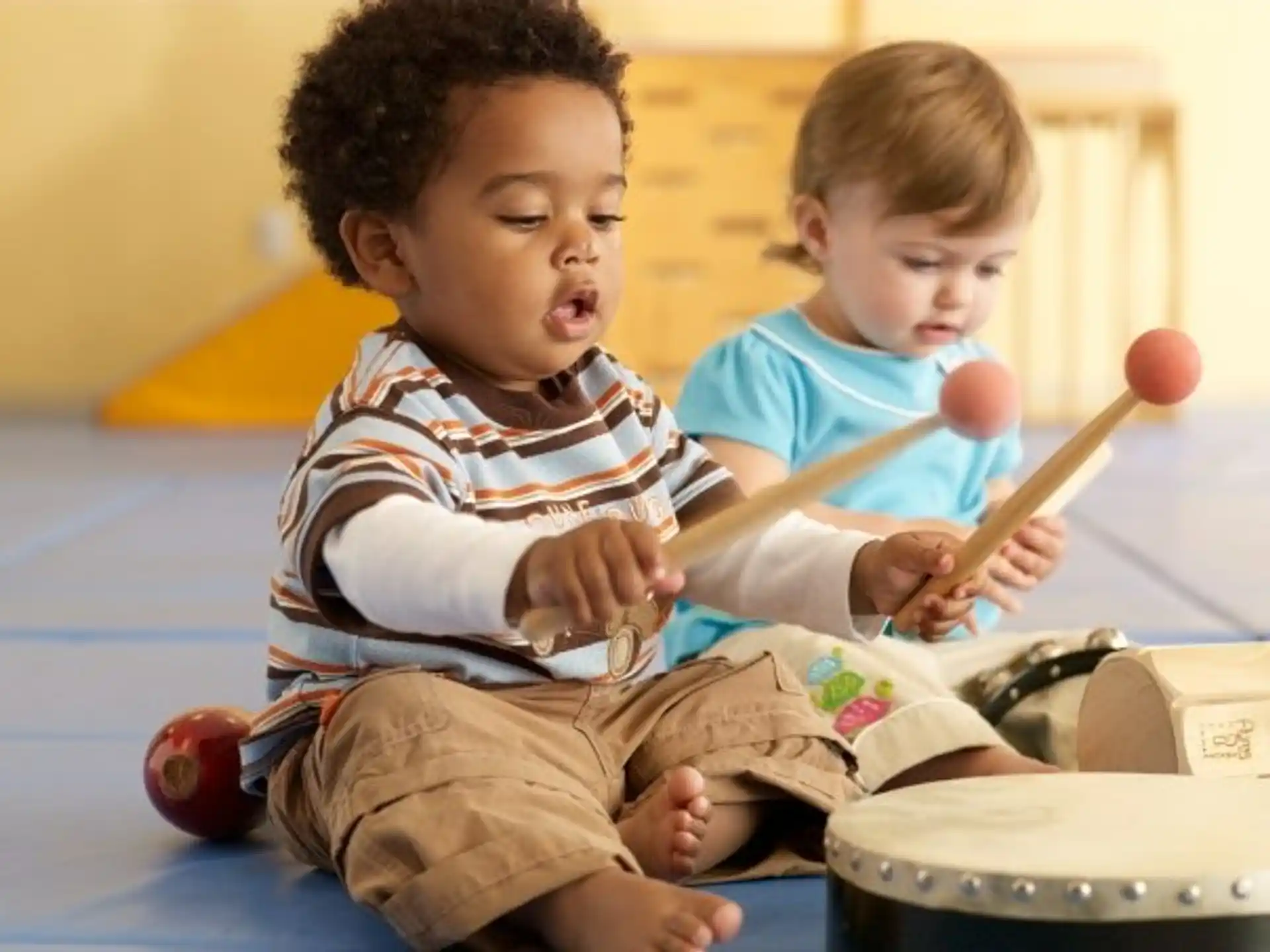 a couple of young boys playing with a toy