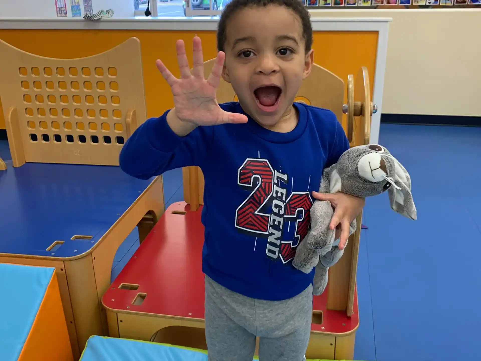 a boy holding a stuffed animal