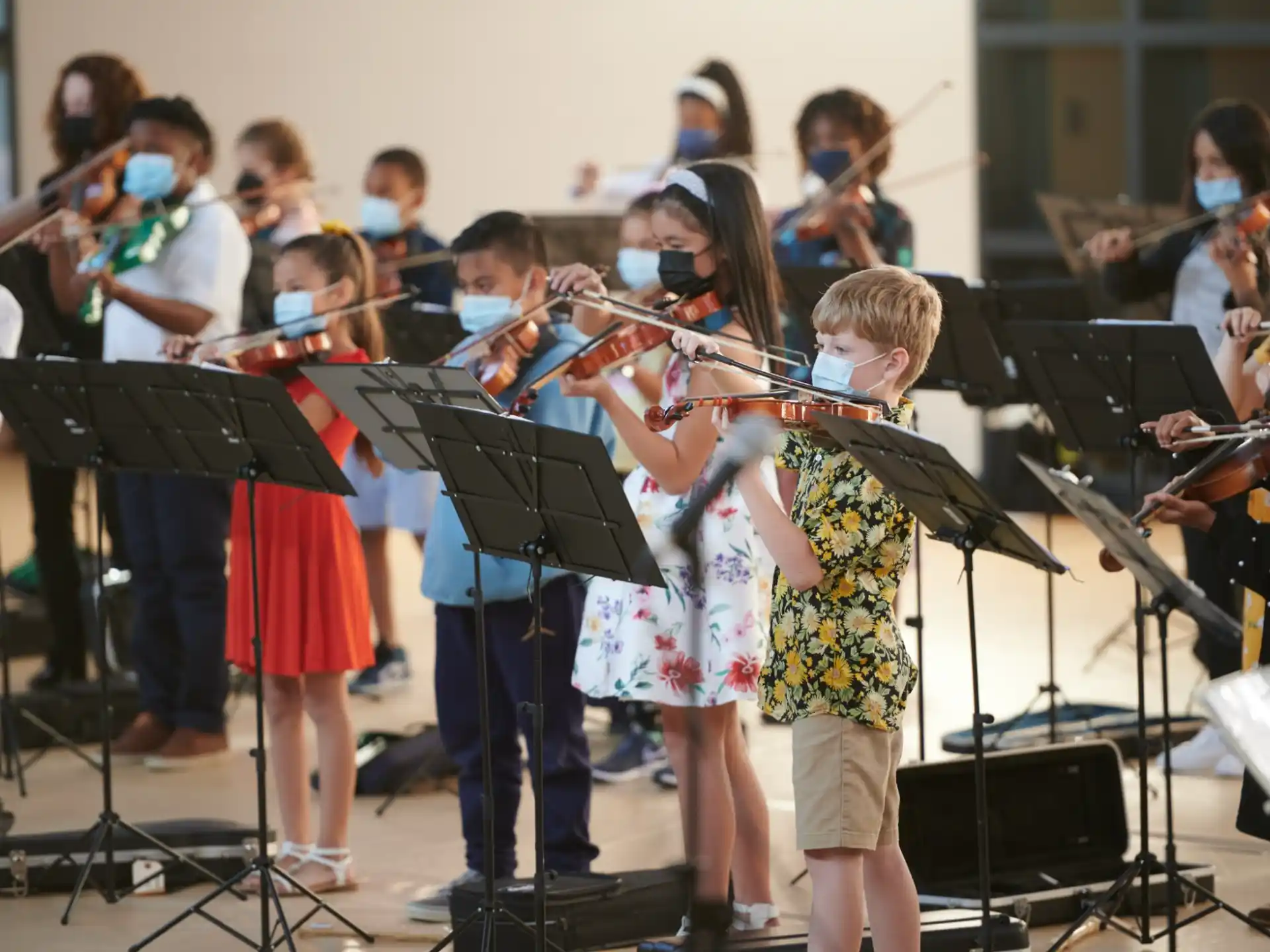 a group of children playing instruments