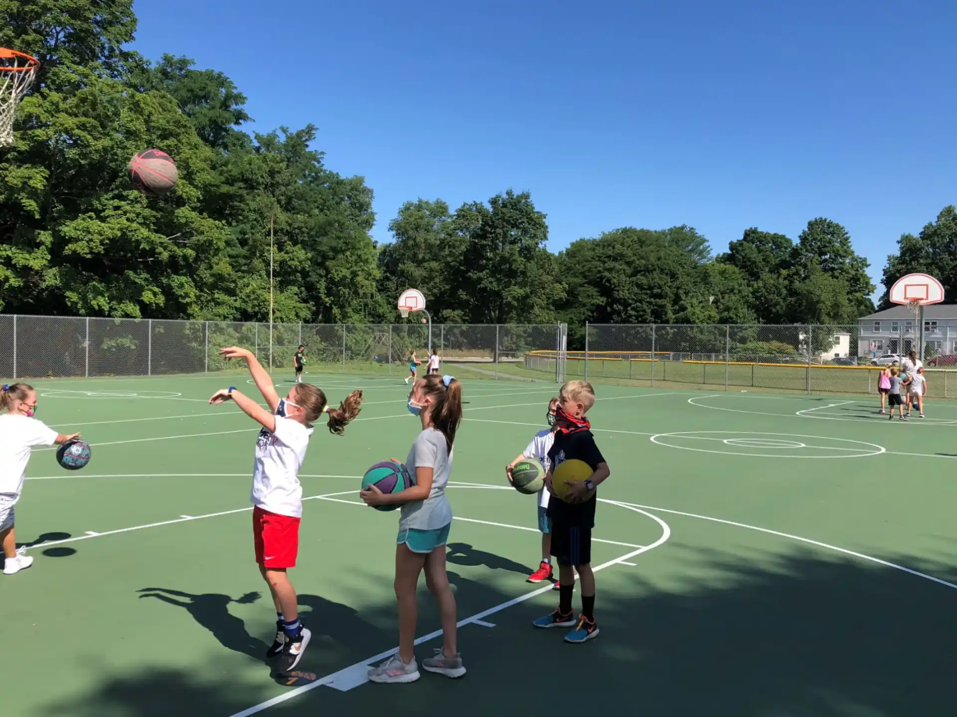 a group of girls playing basketball