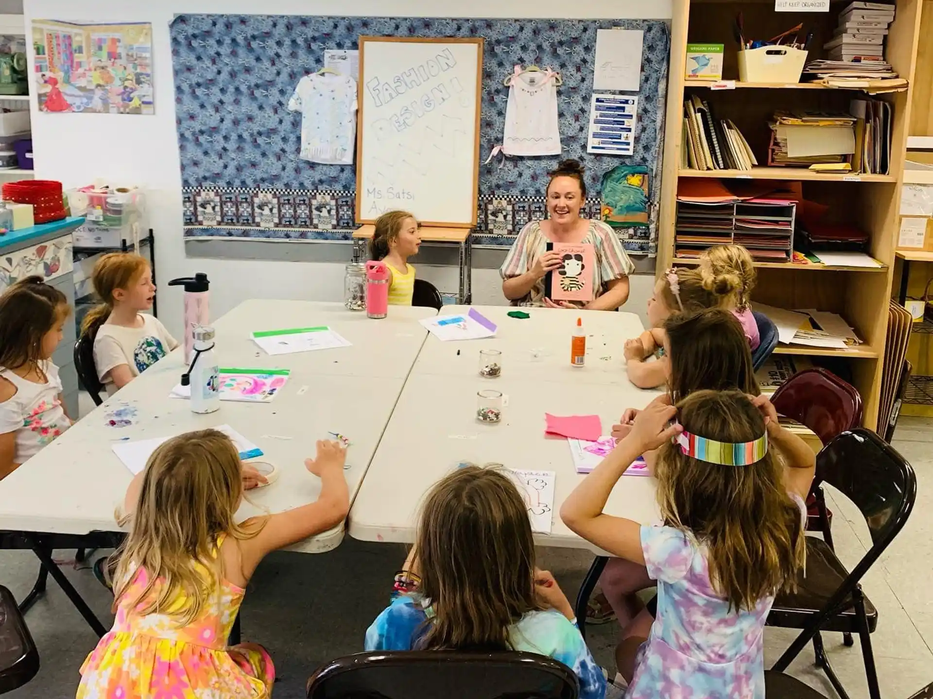 a group of children sitting around a table