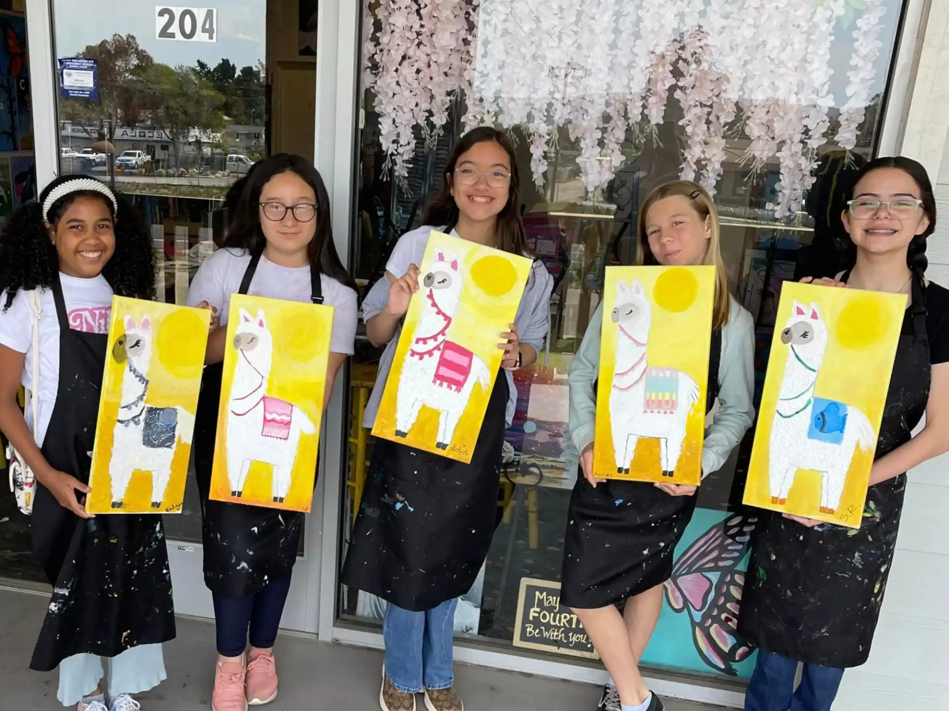 a group of girls holding signs