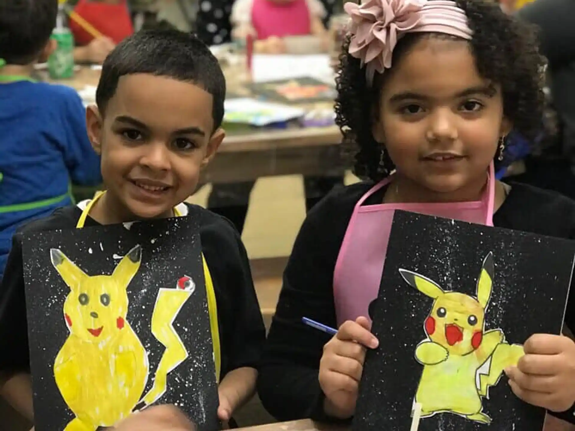 a couple of children holding books