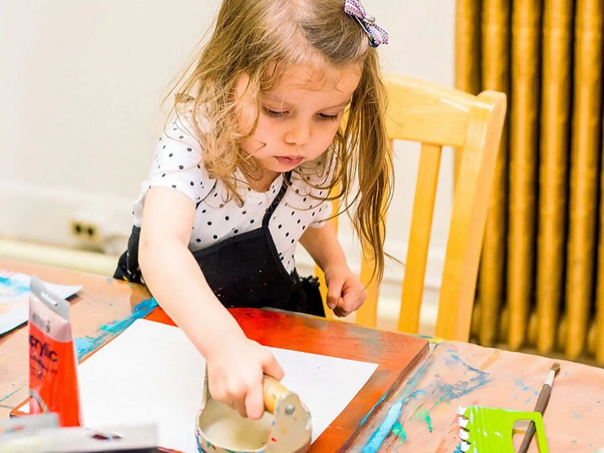 a girl painting on a table