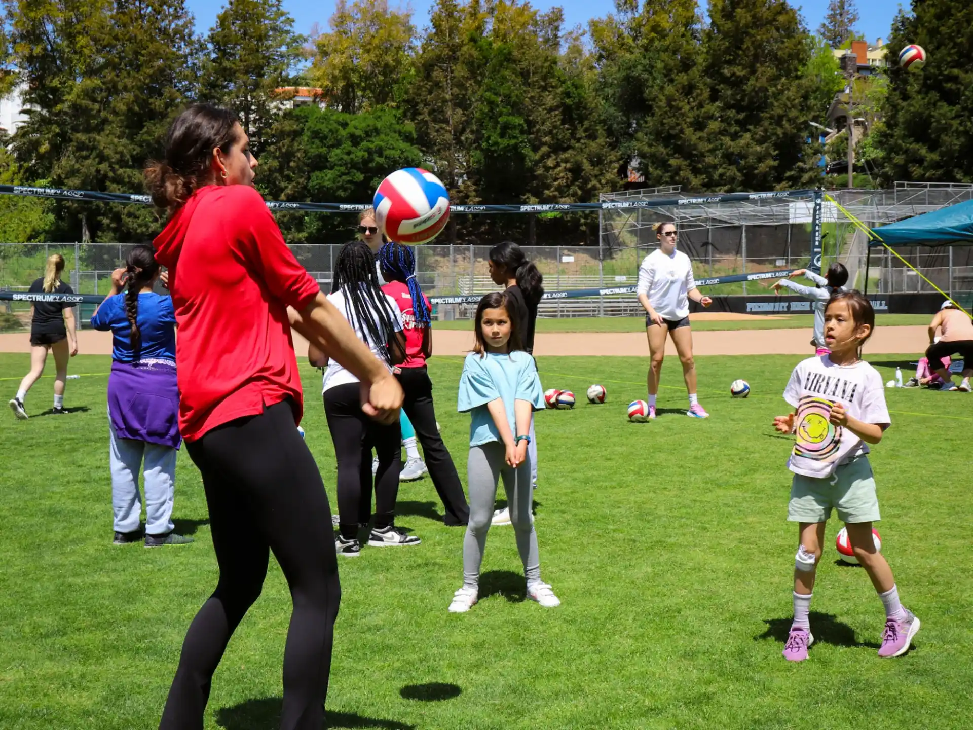 a person and a group of children playing football