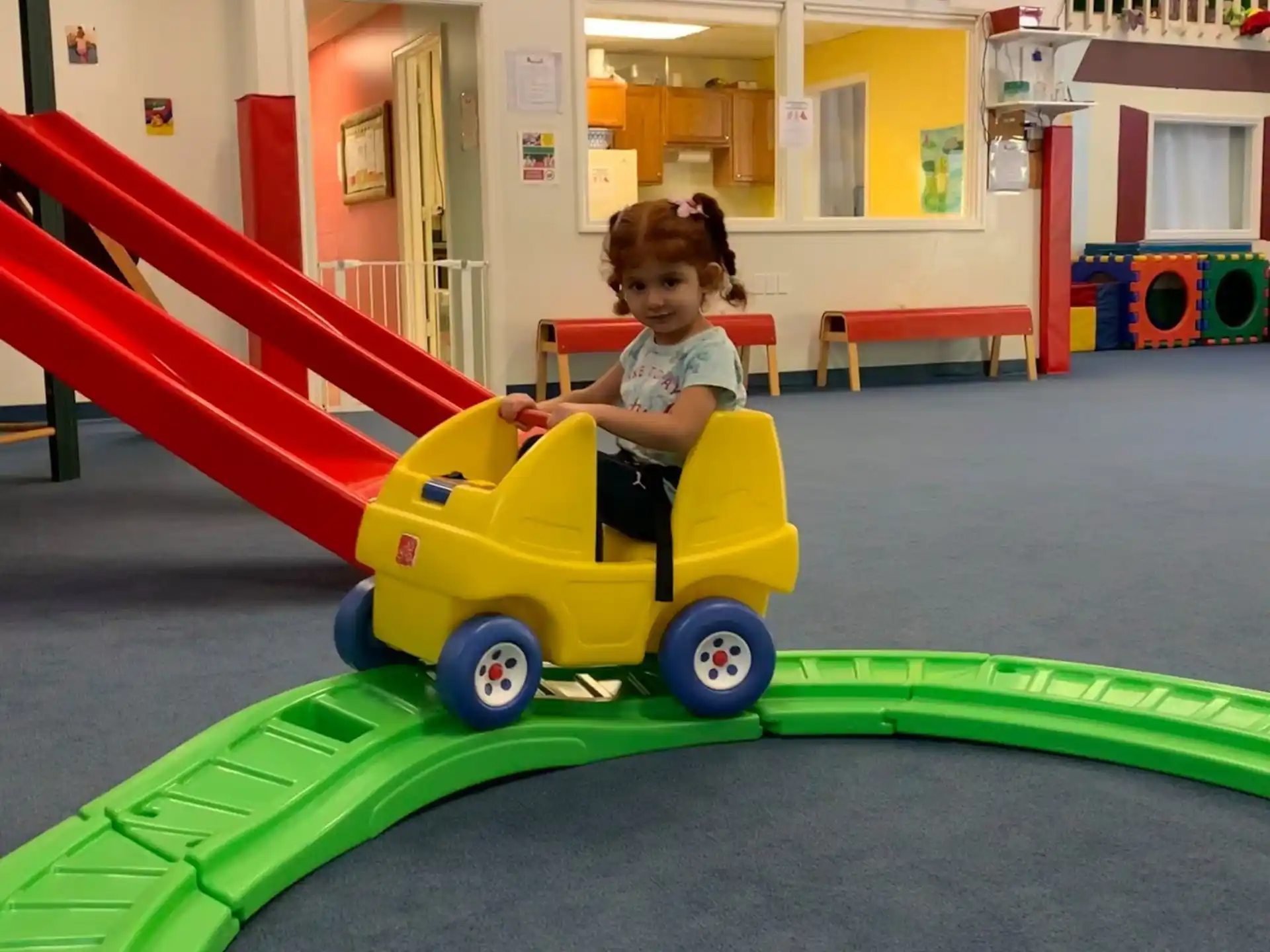a child riding a toy train