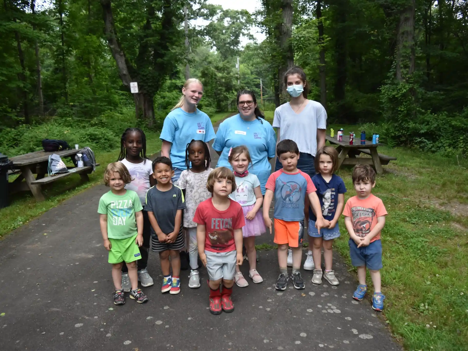 a group of people posing for a photo in the woods