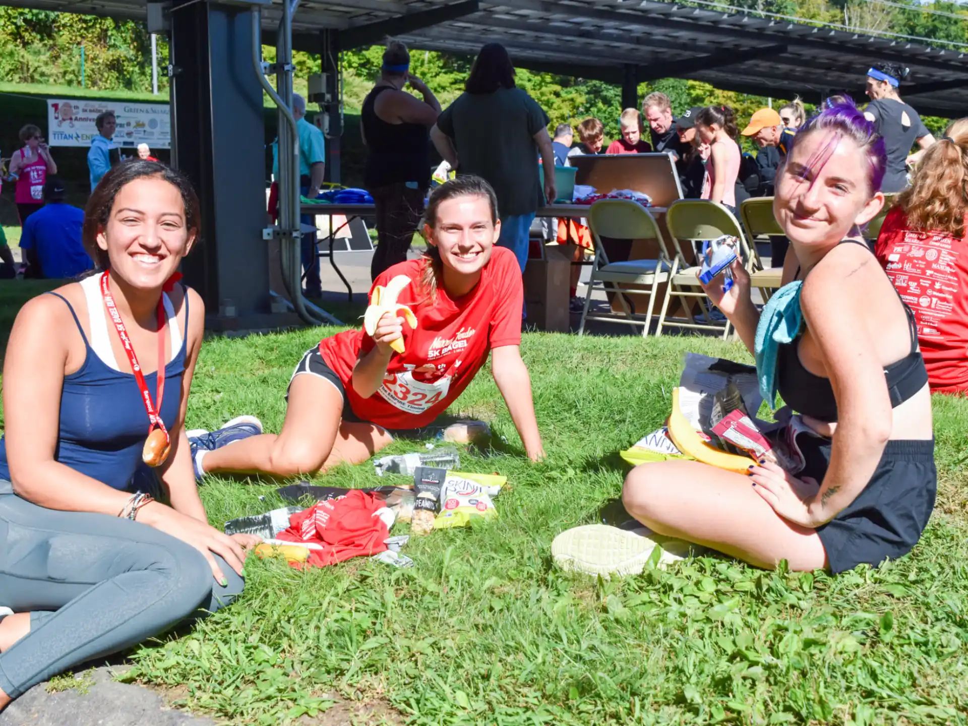 a group of women sitting on the grass