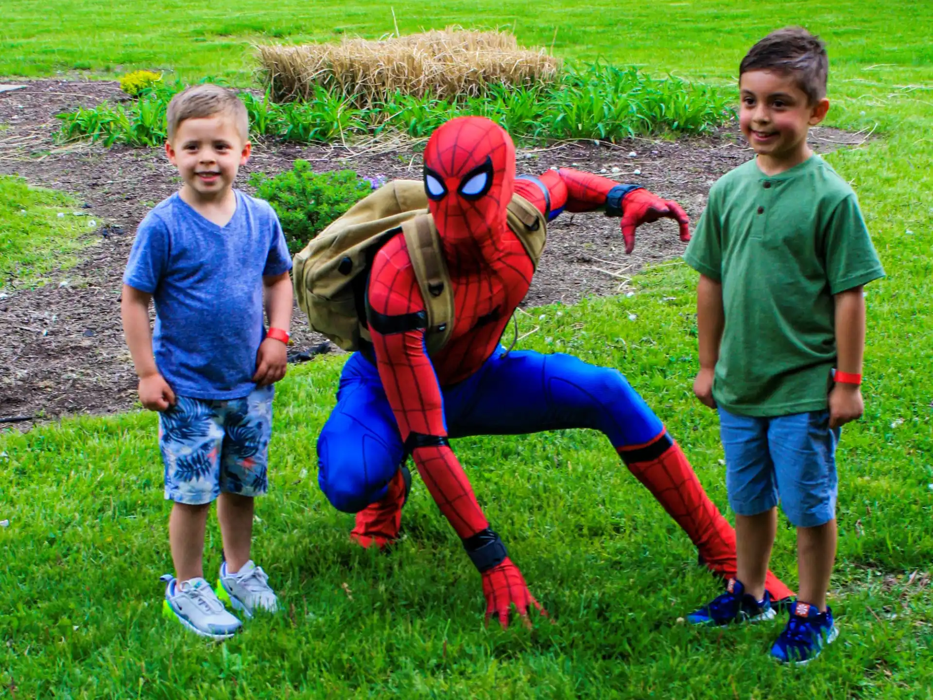 a group of kids standing next to a person in a garment