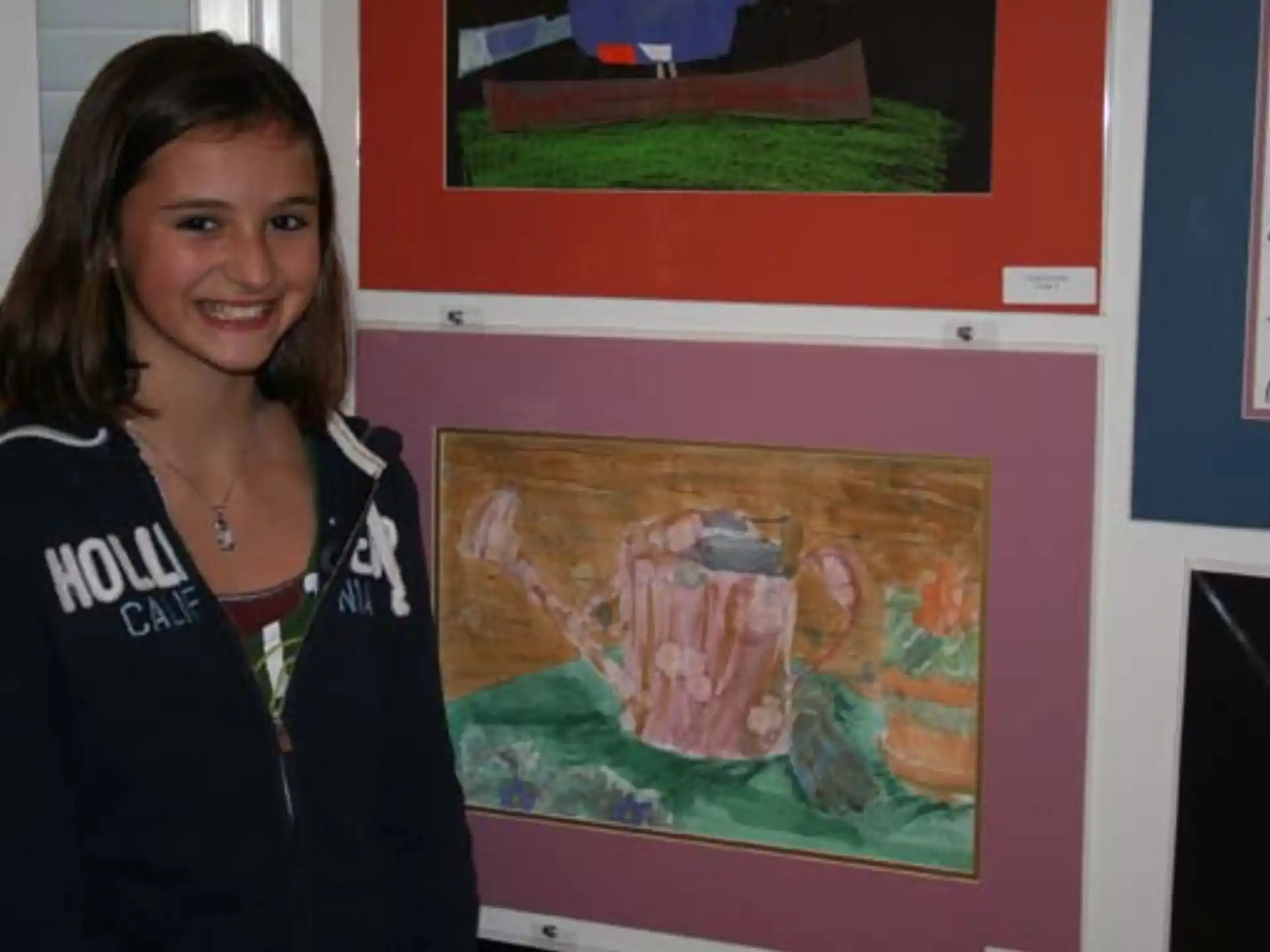 a person standing next to a wall with art on it