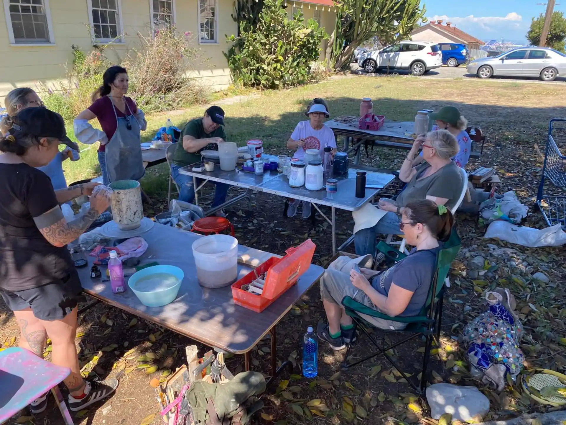 a group of people sitting around a table outside