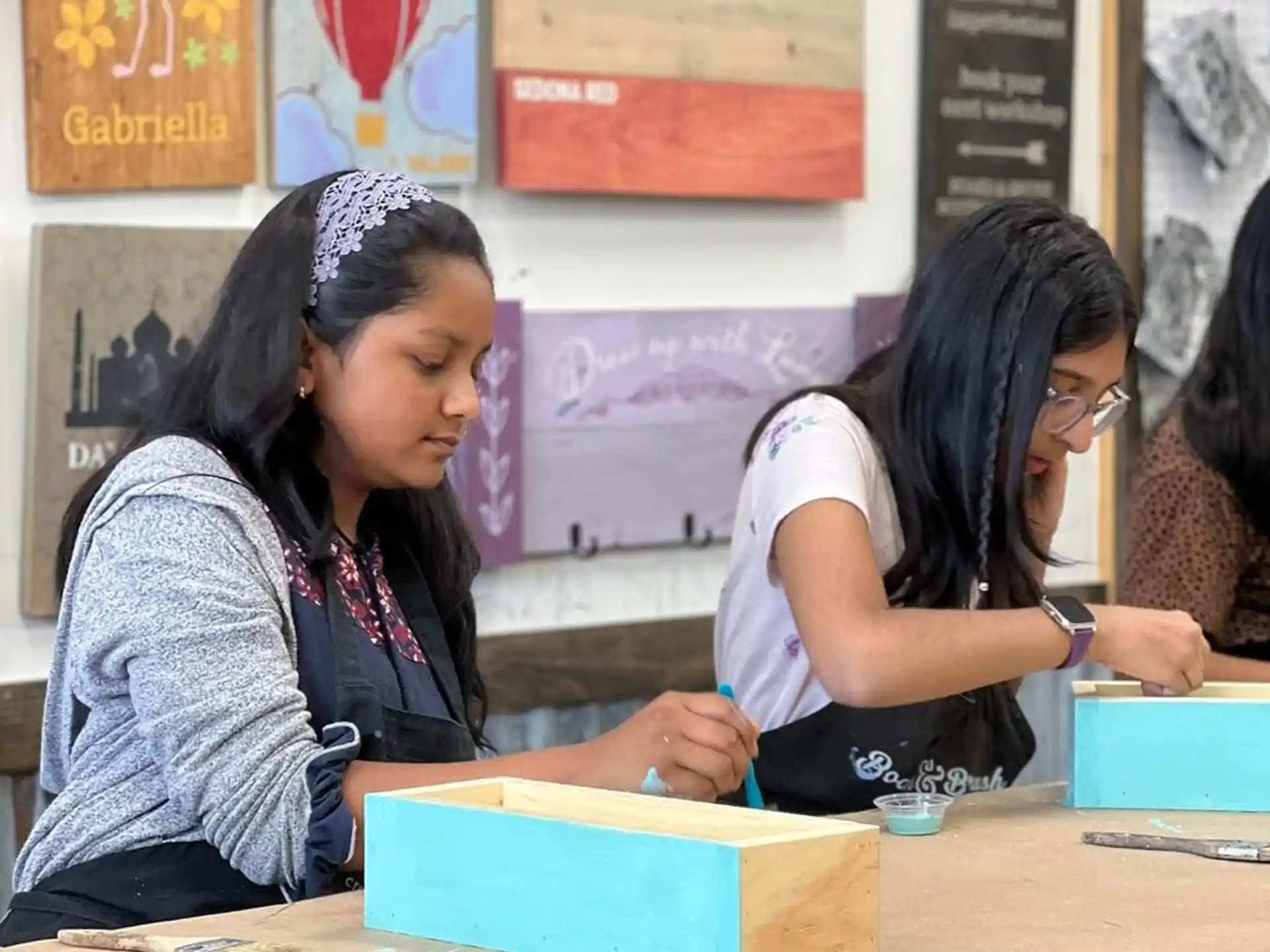 a few young girls sitting at a table