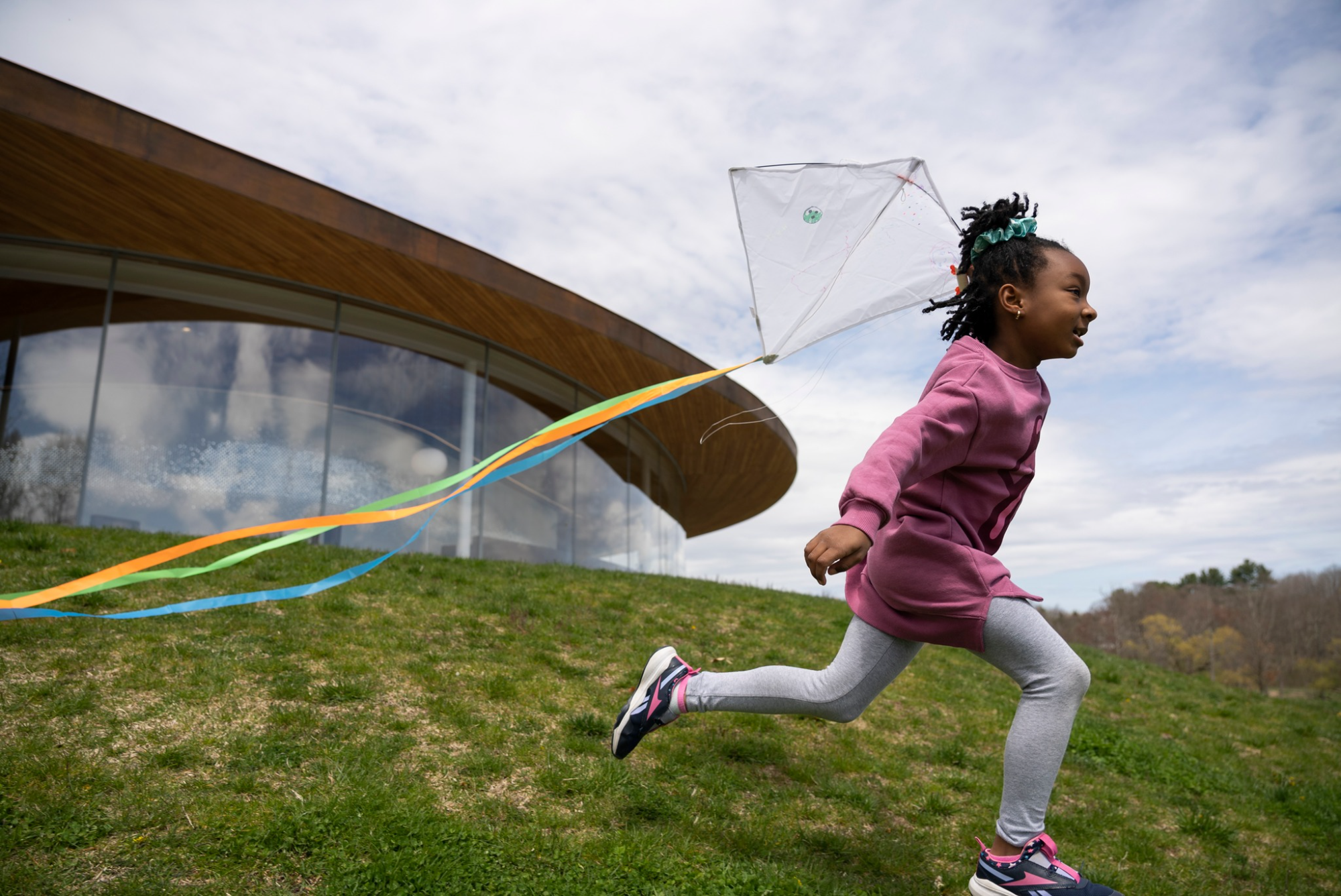 a girl running with a kite