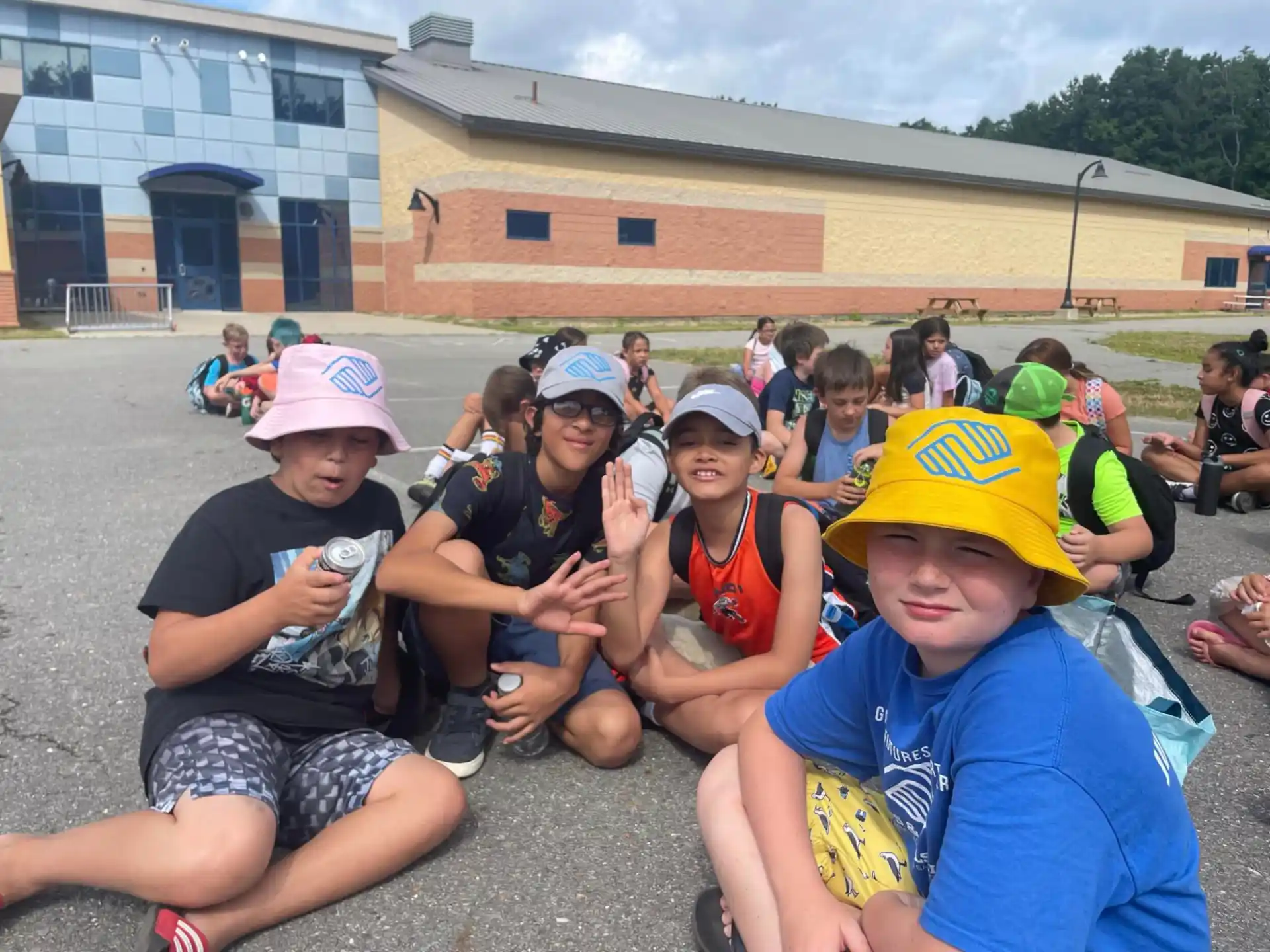 a group of people sitting on the ground outside