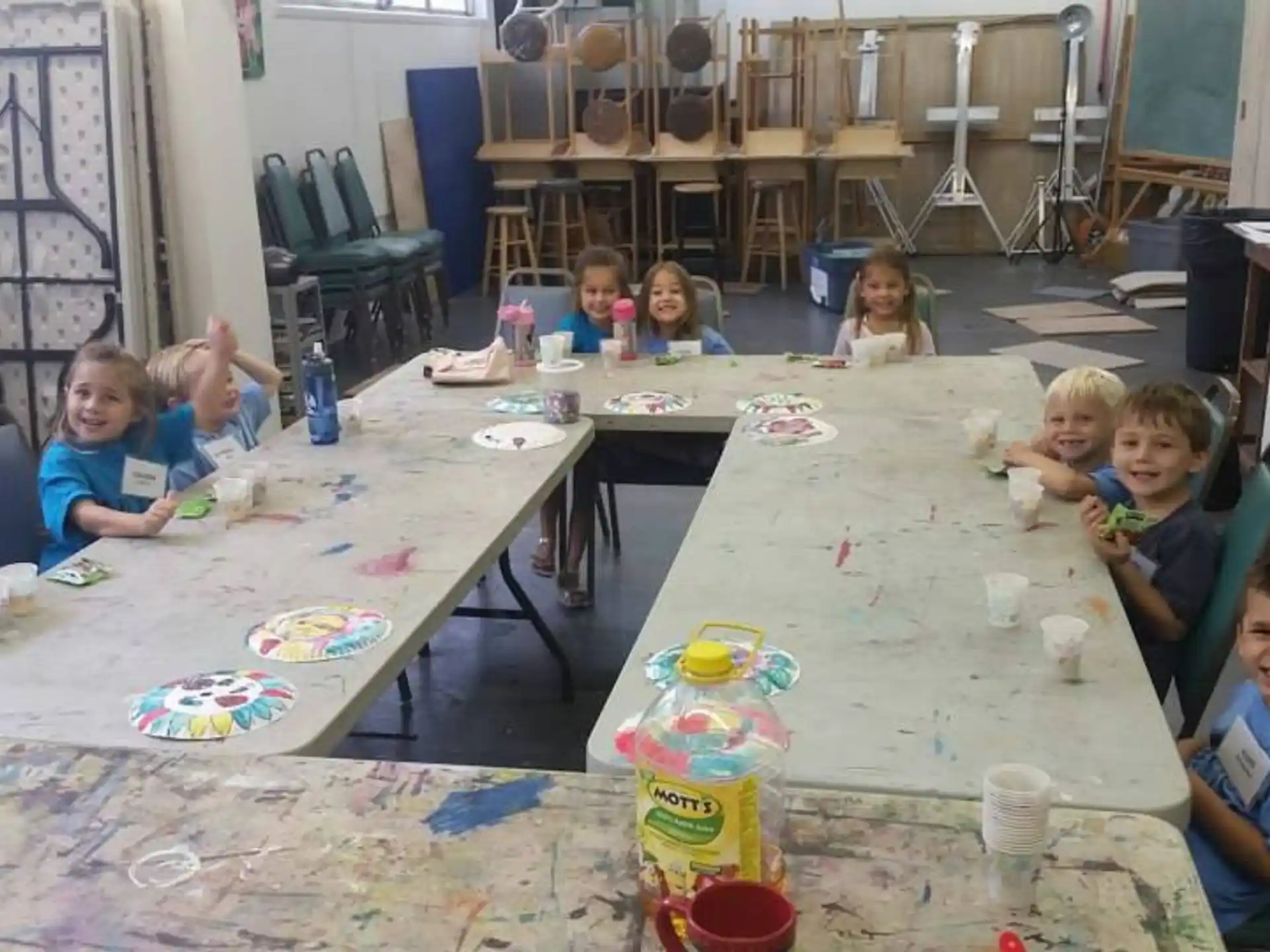 a group of children sitting around a table