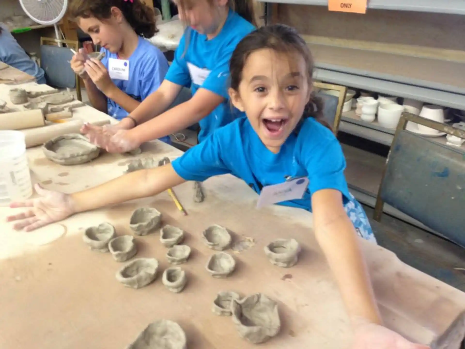a young girl making clay