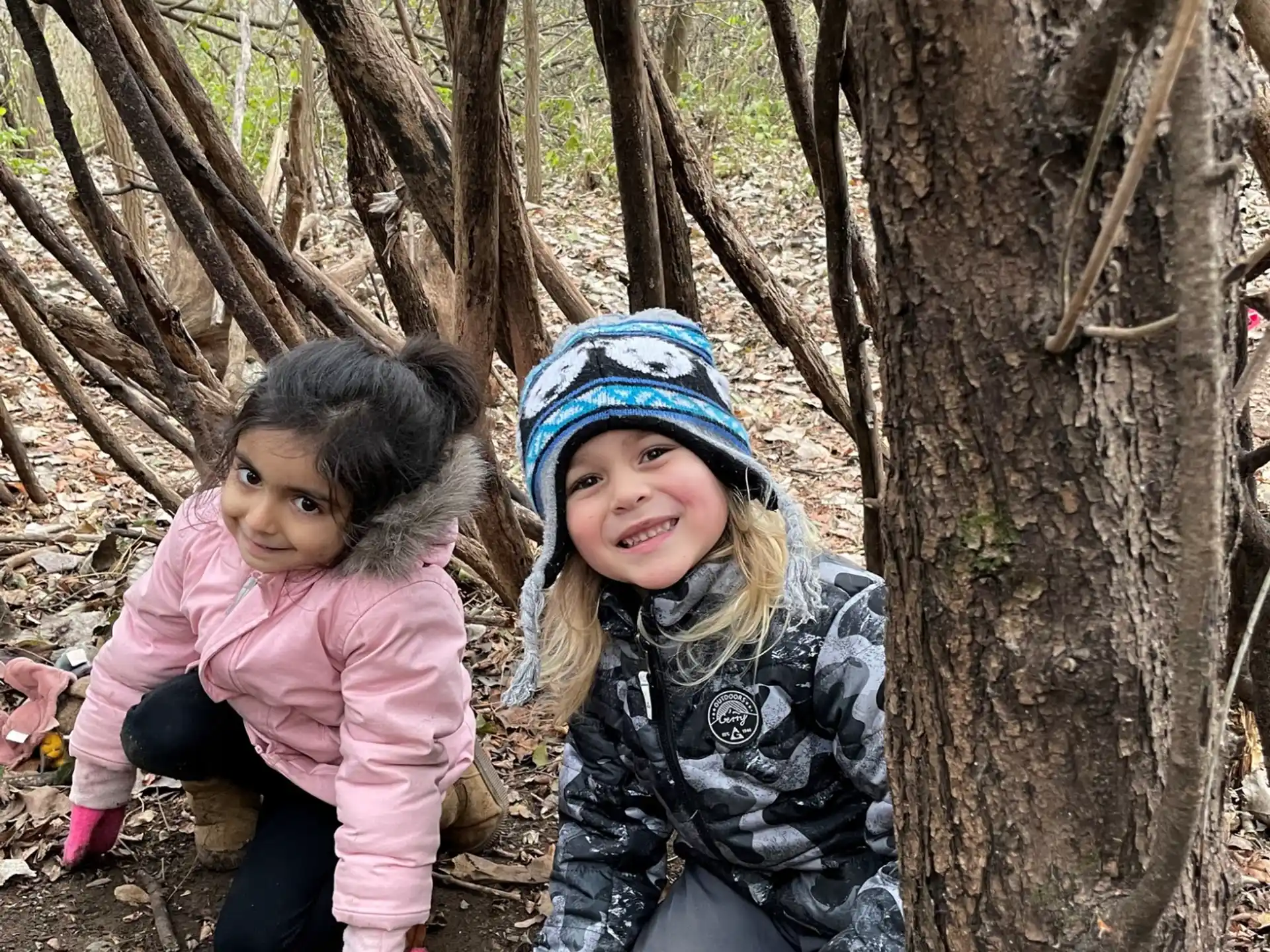 a couple of children sitting in a tree