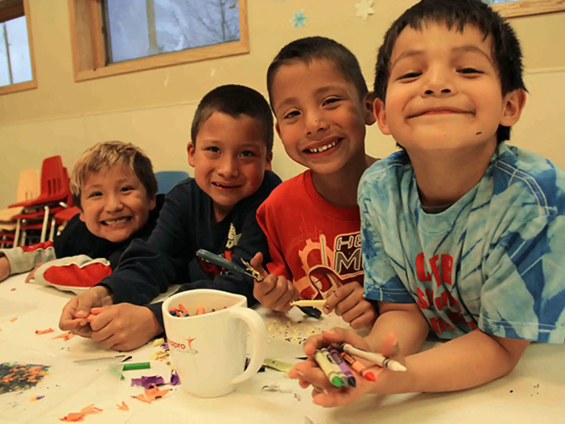 a group of boys sitting at a table