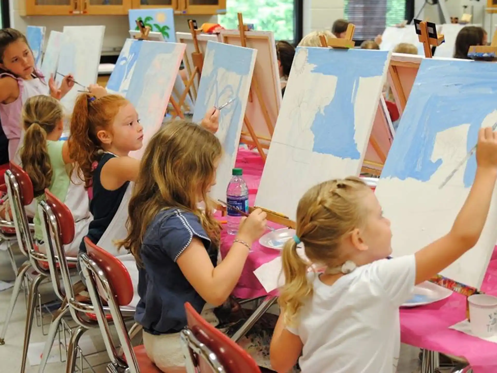 a group of children painting