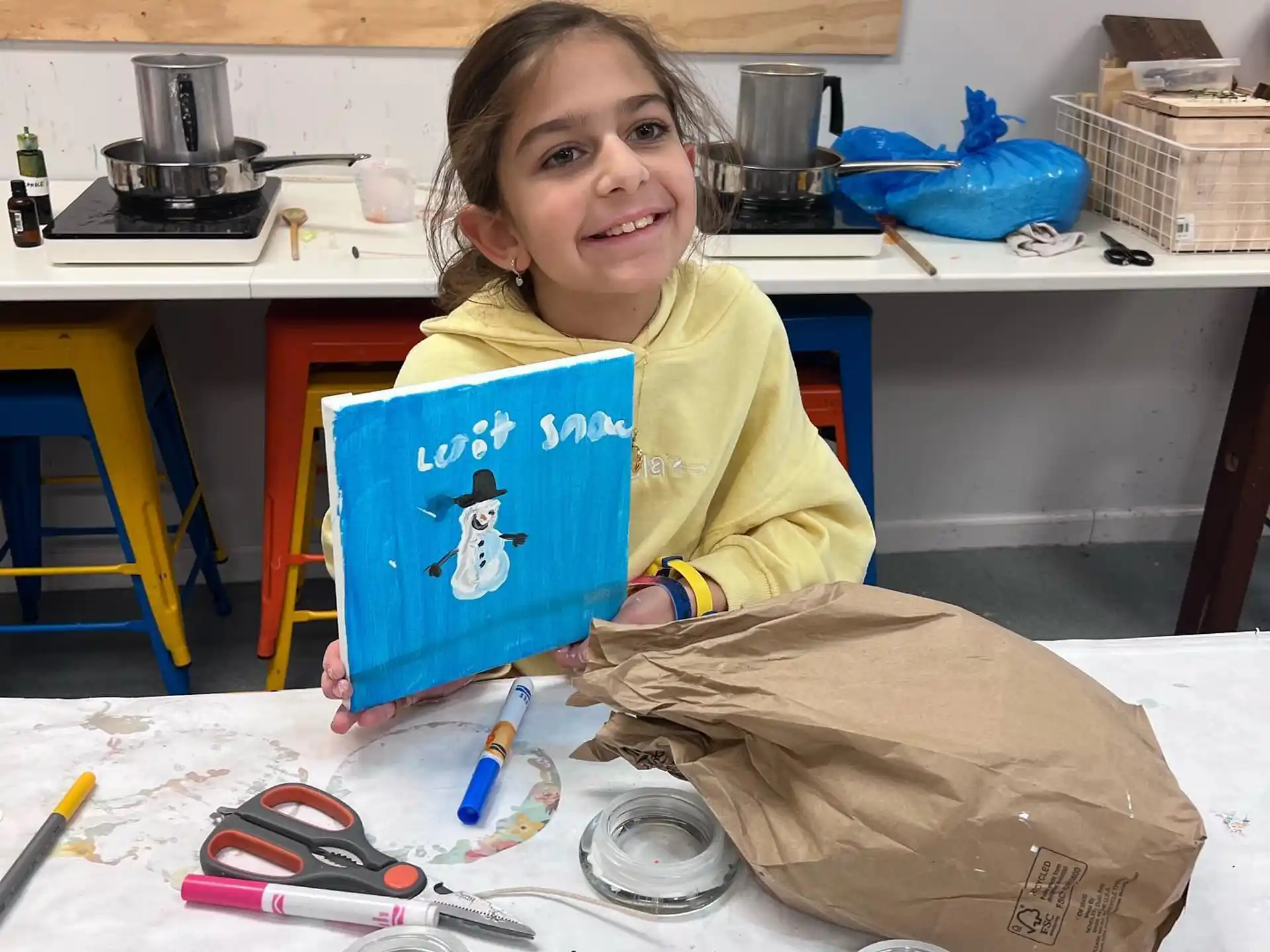a girl holding a blue laptop