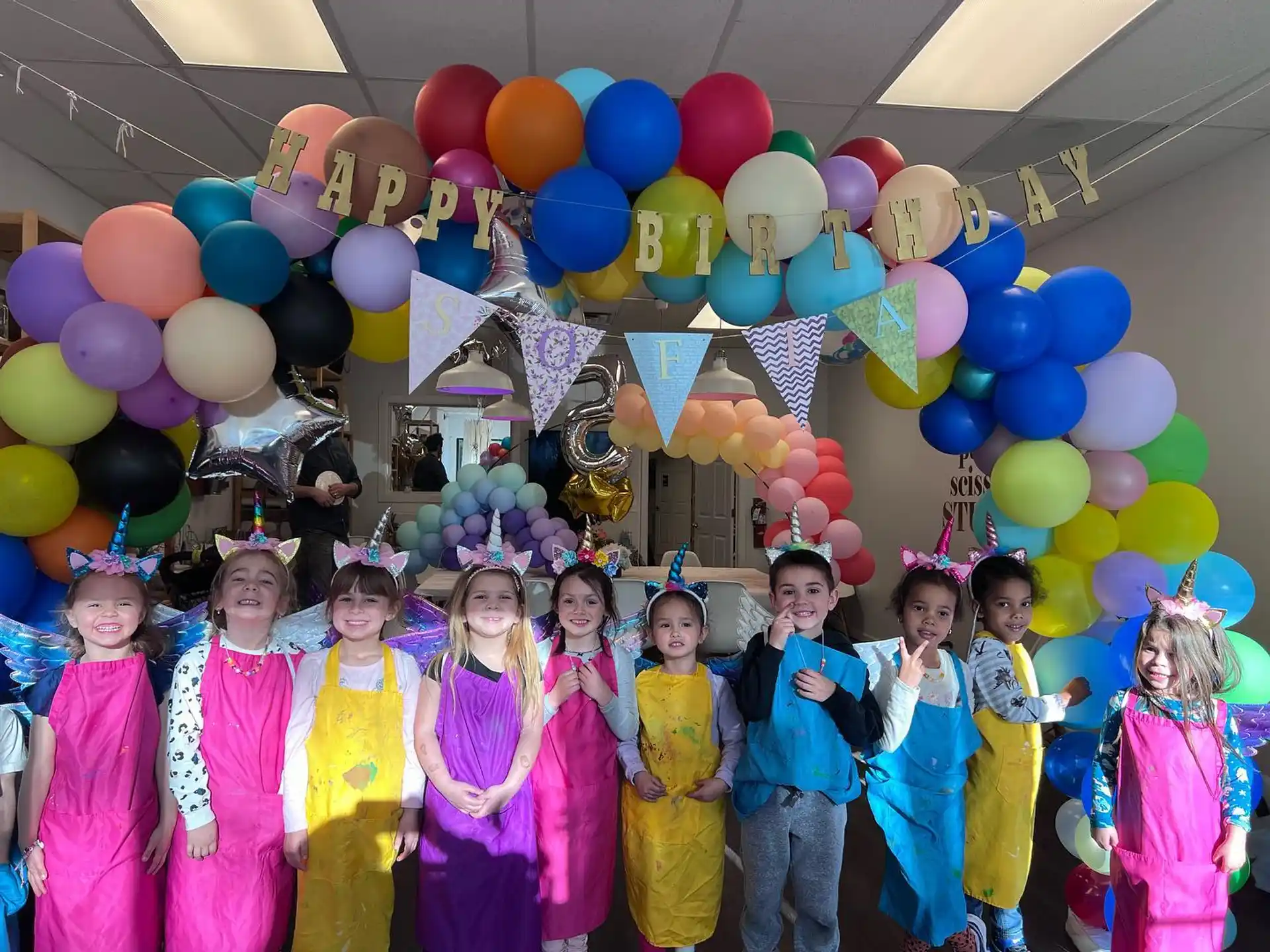 a group of people posing for a photo with balloons